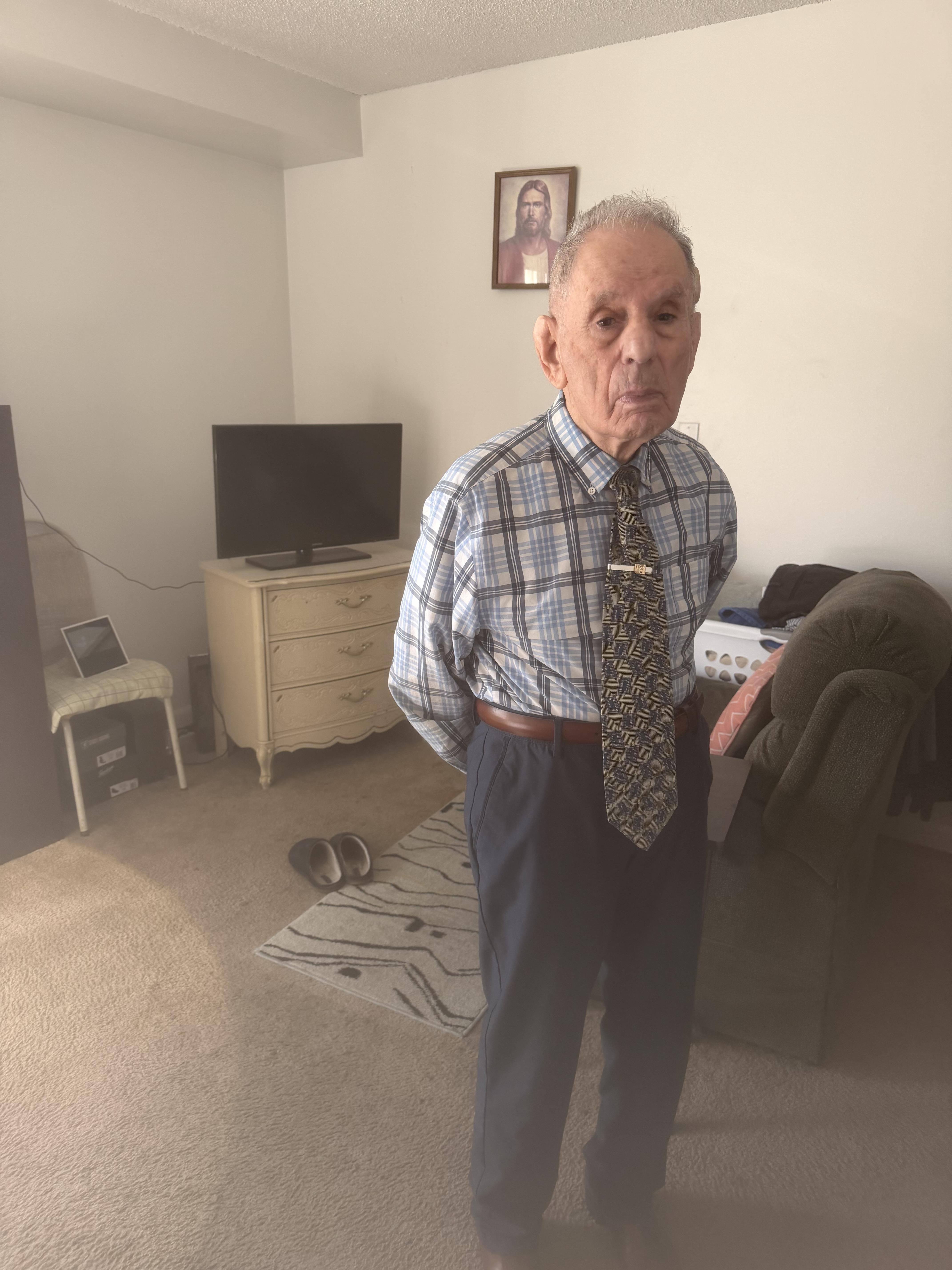 An old man standing in a room