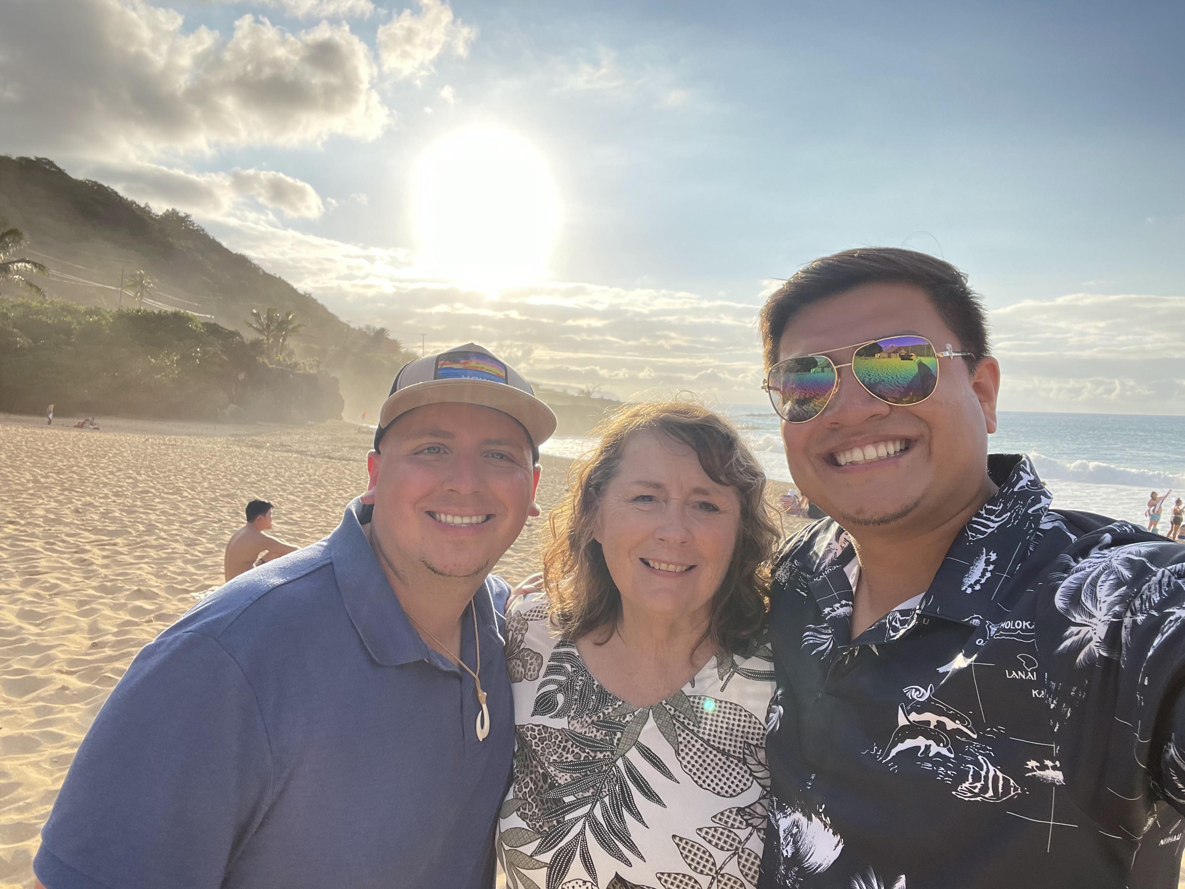 A group of people posing for a photo on a beach
