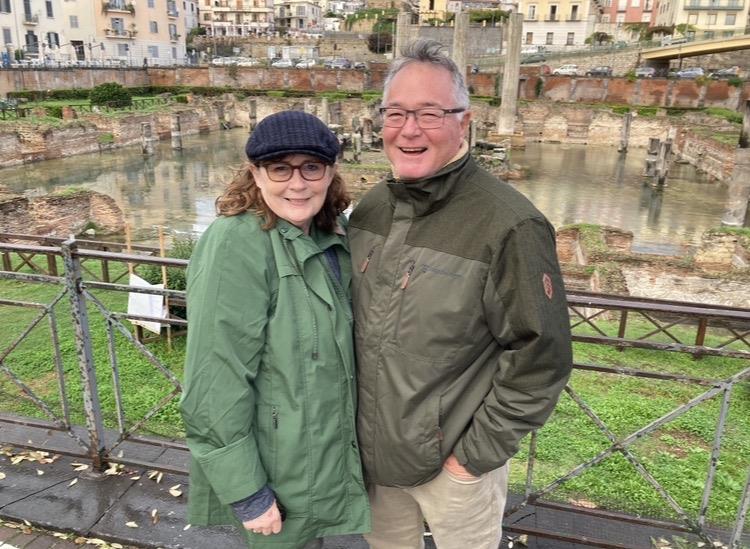 A man and woman standing on a bridge