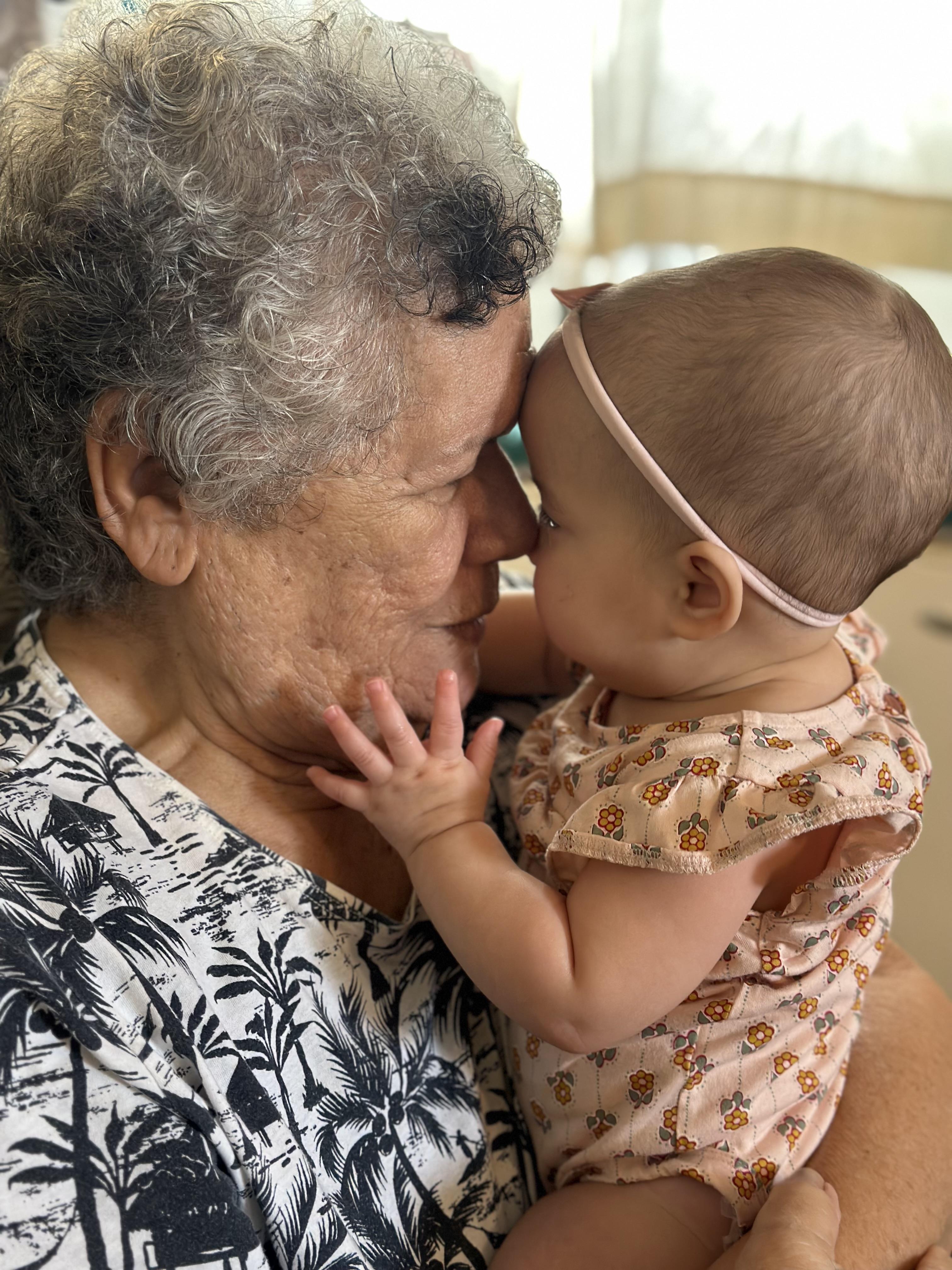 An old woman holding a baby