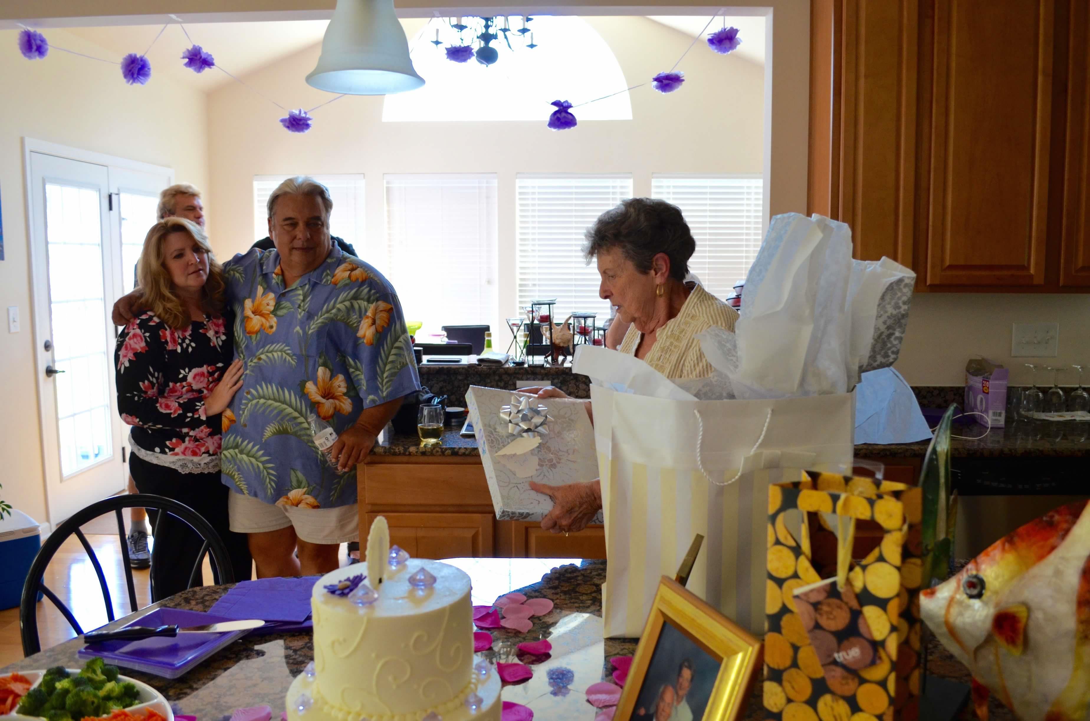 A group of people standing around a table