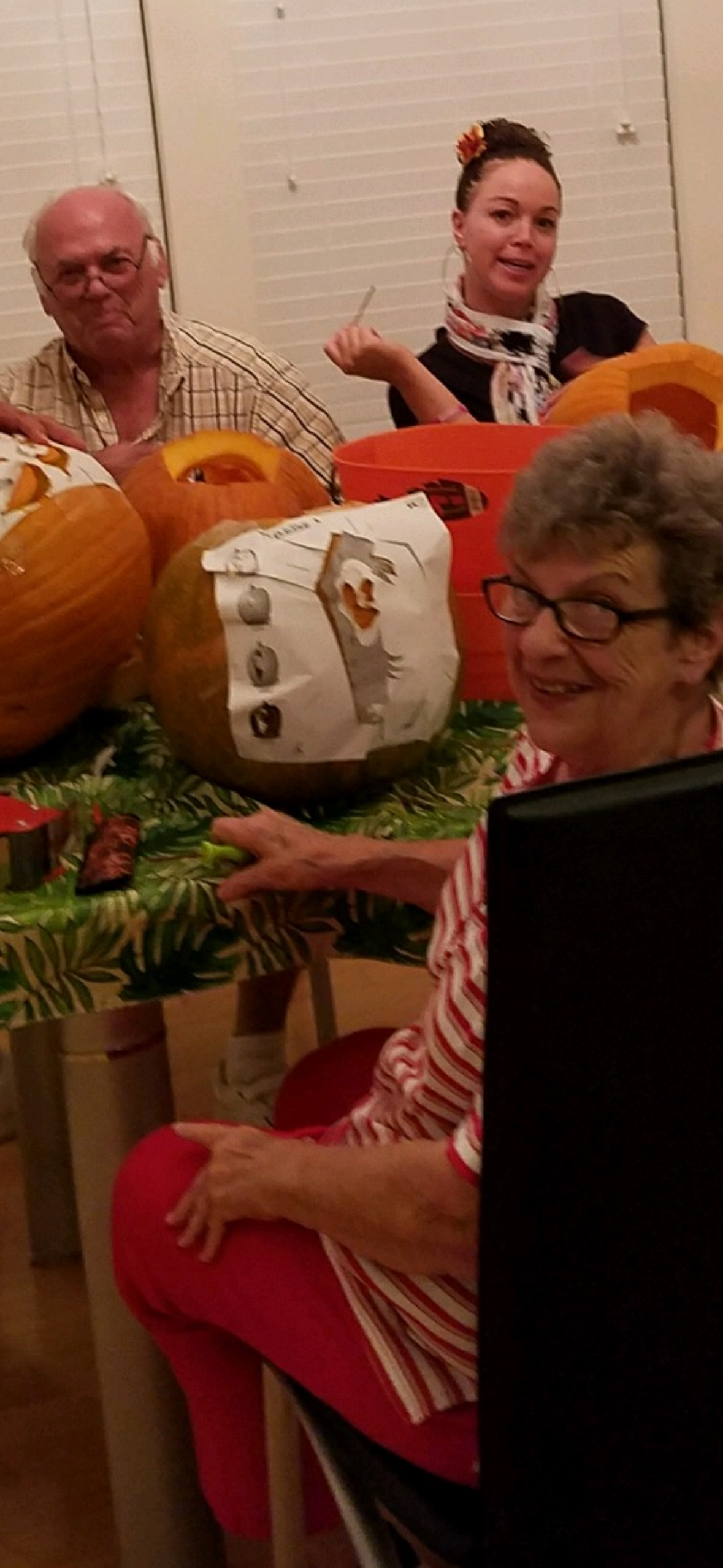 A woman sitting at a table with a pumpkin