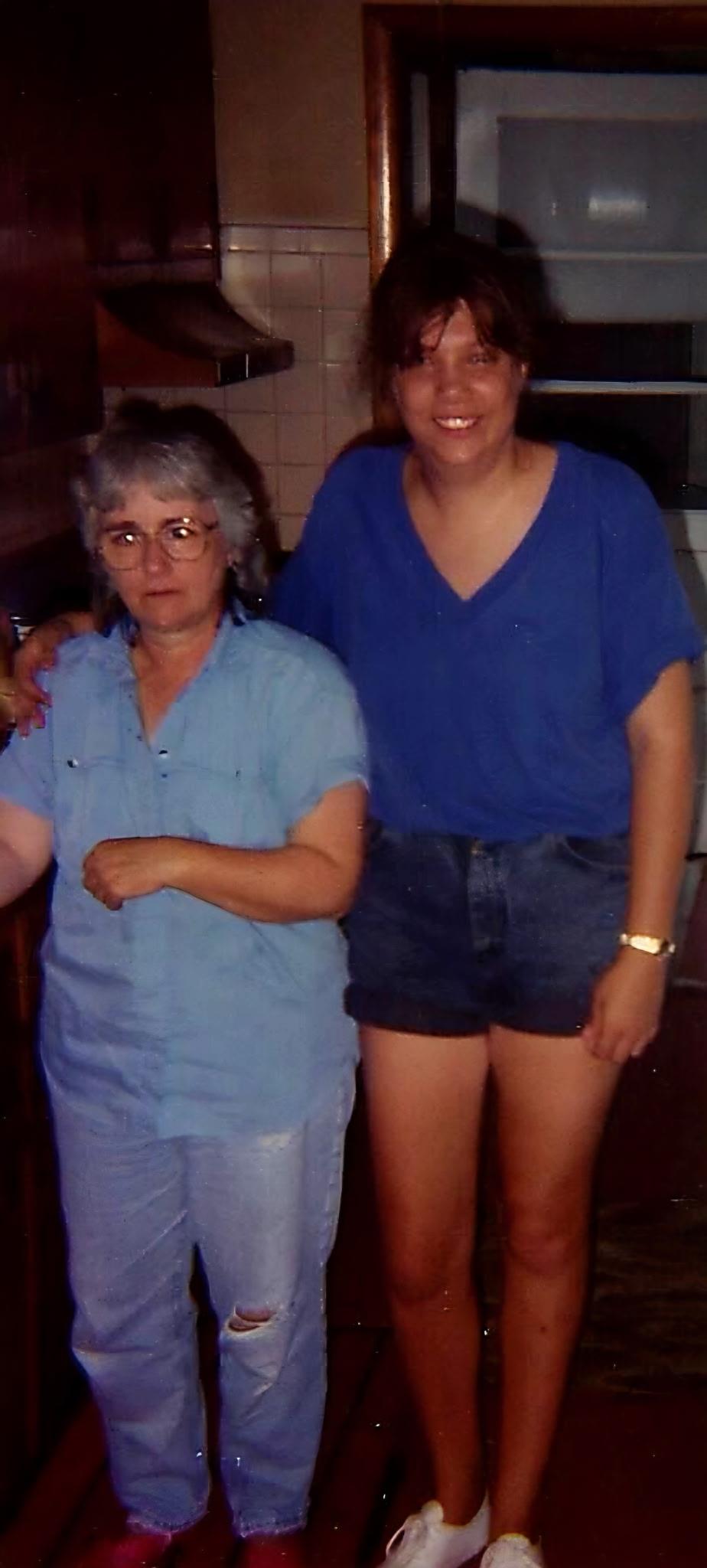 A woman standing next to another woman