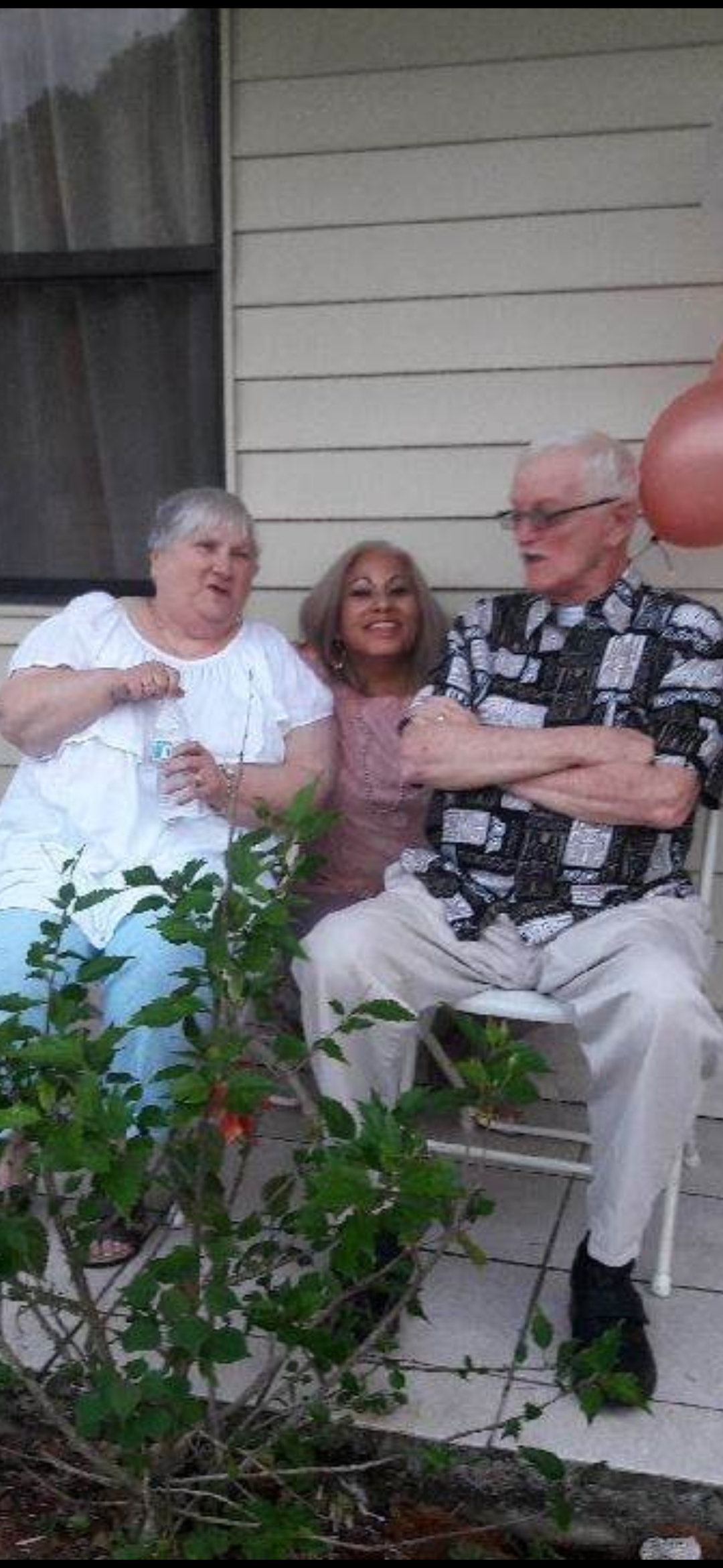 A group of people sitting on a porch