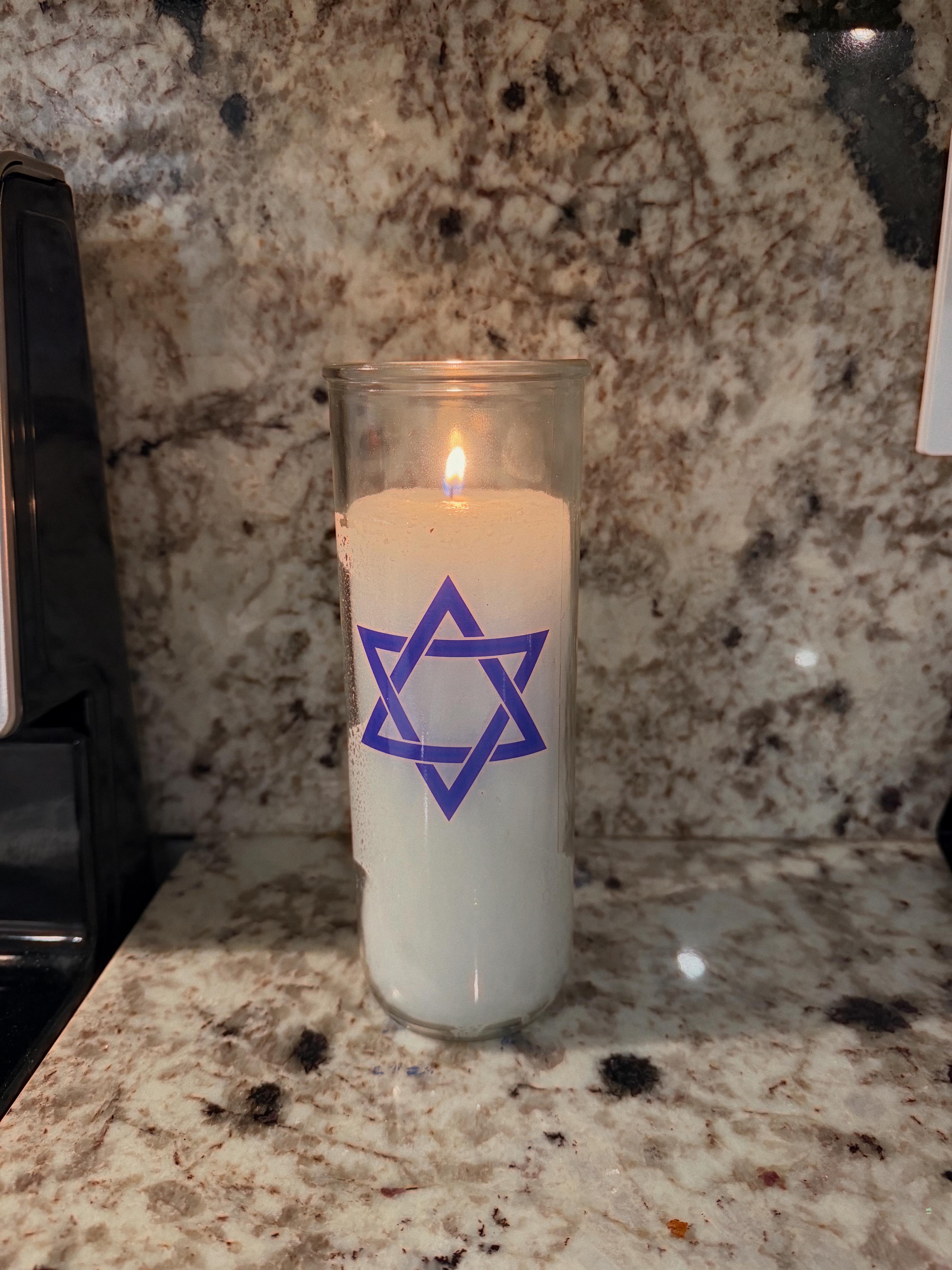 A candle in a glass container