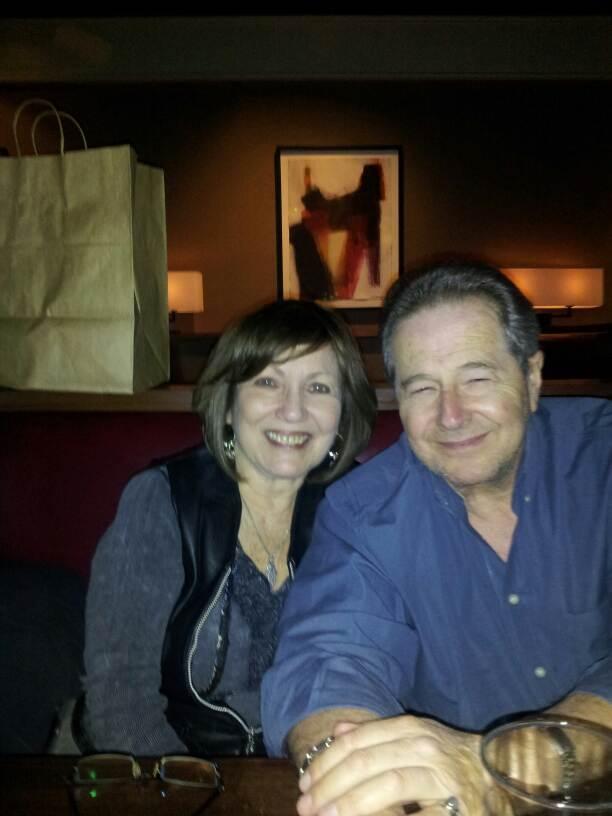 A man and woman sitting together smiling