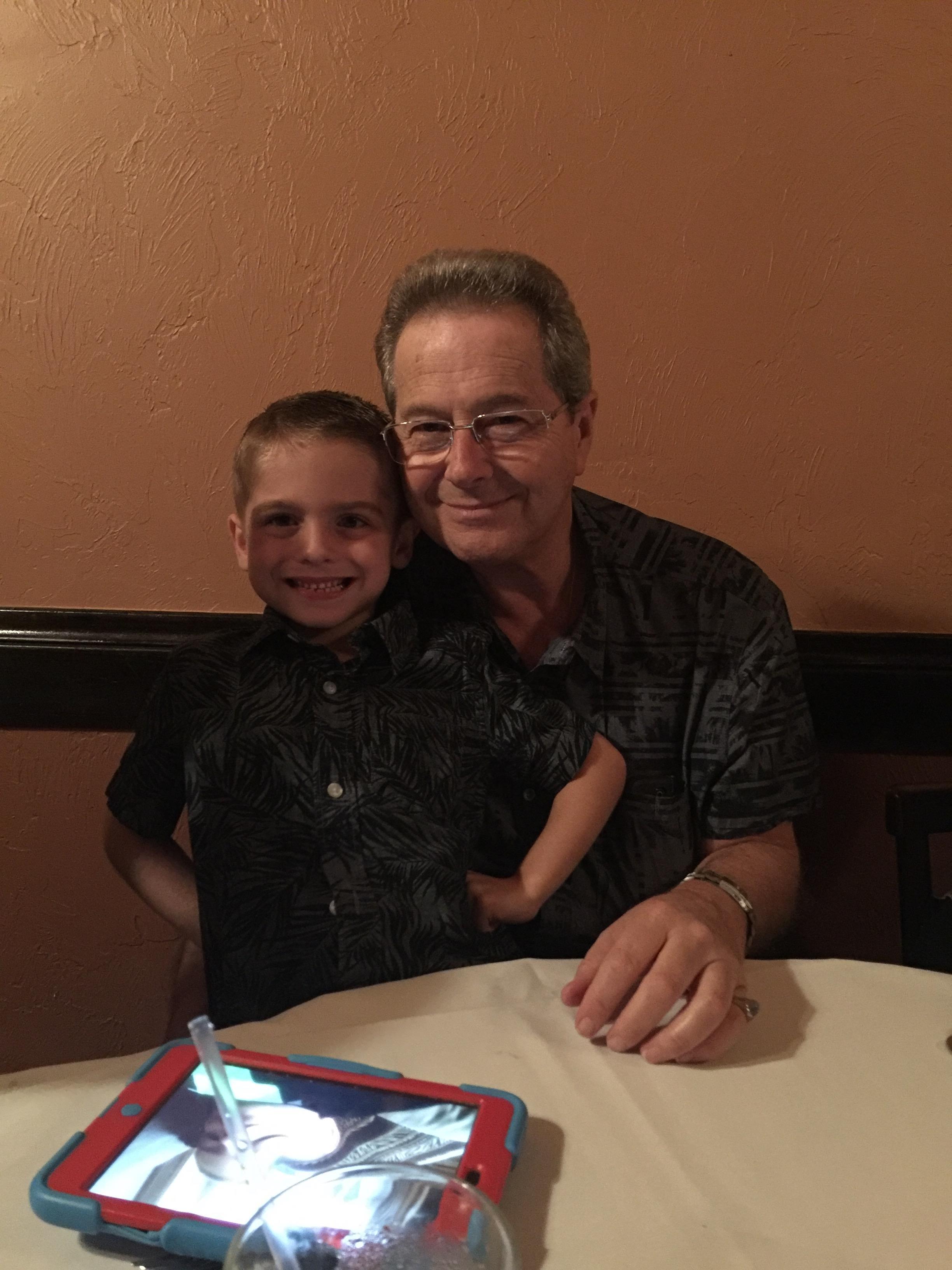 A man and boy sitting at a table