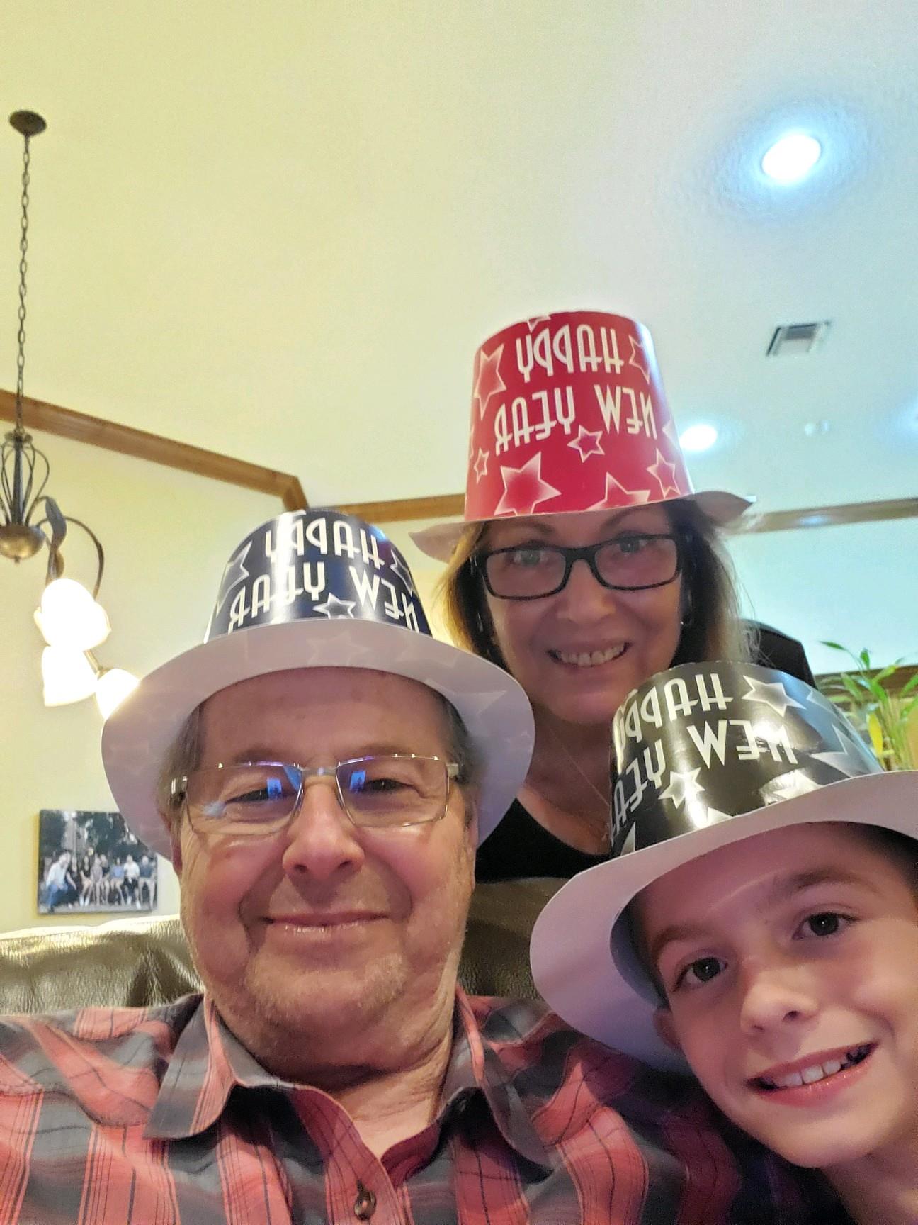 A group of people wearing paper buckets