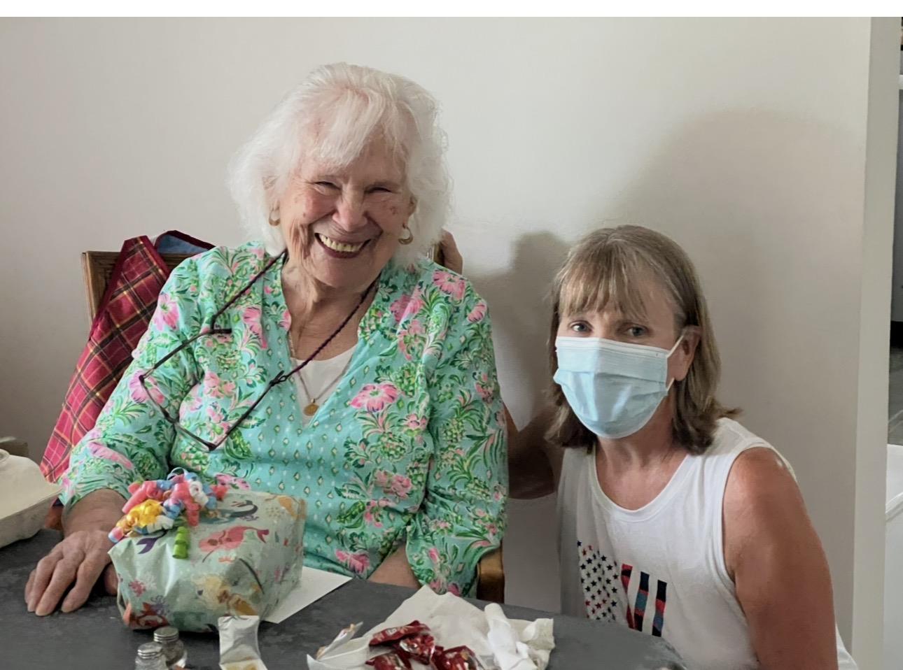 A woman and a girl wearing face masks