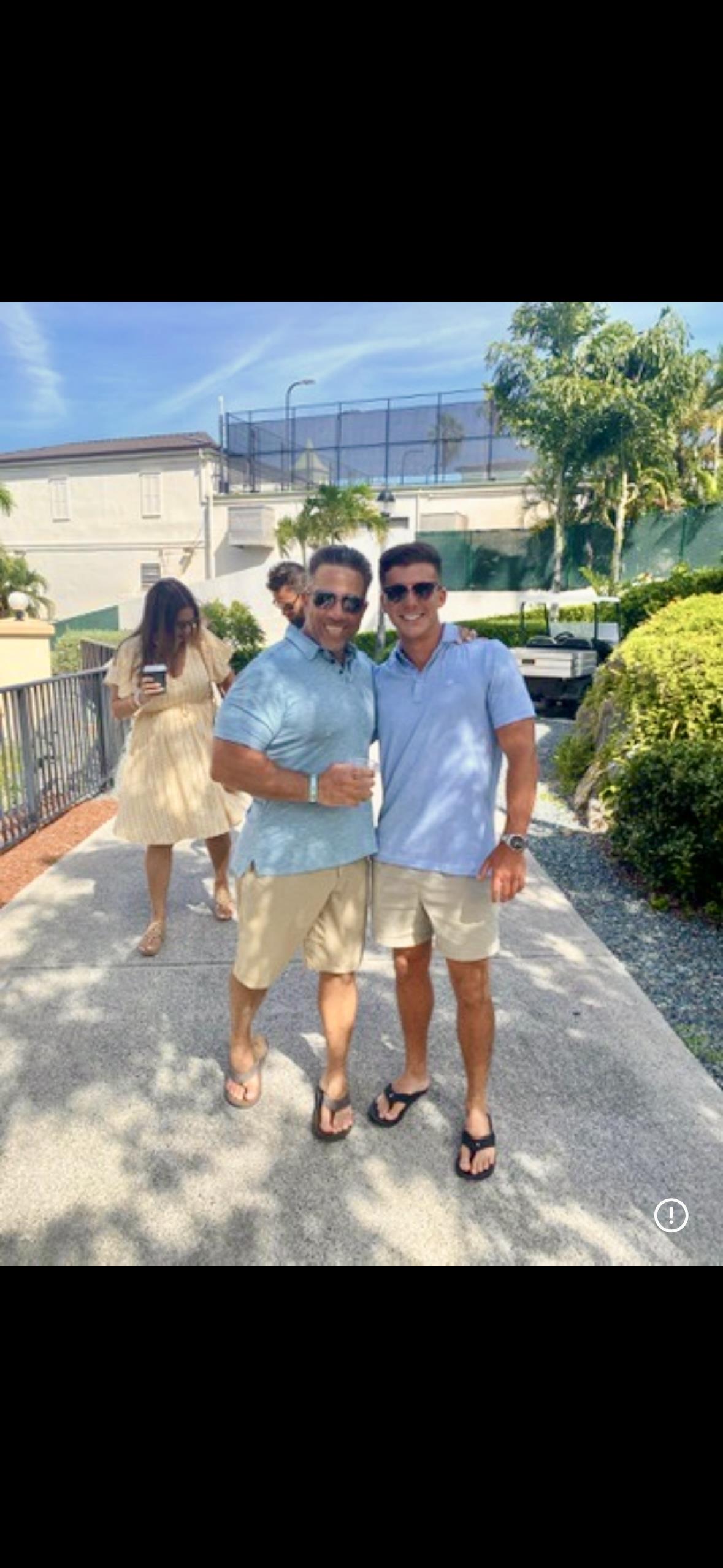 Two men standing on a sidewalk