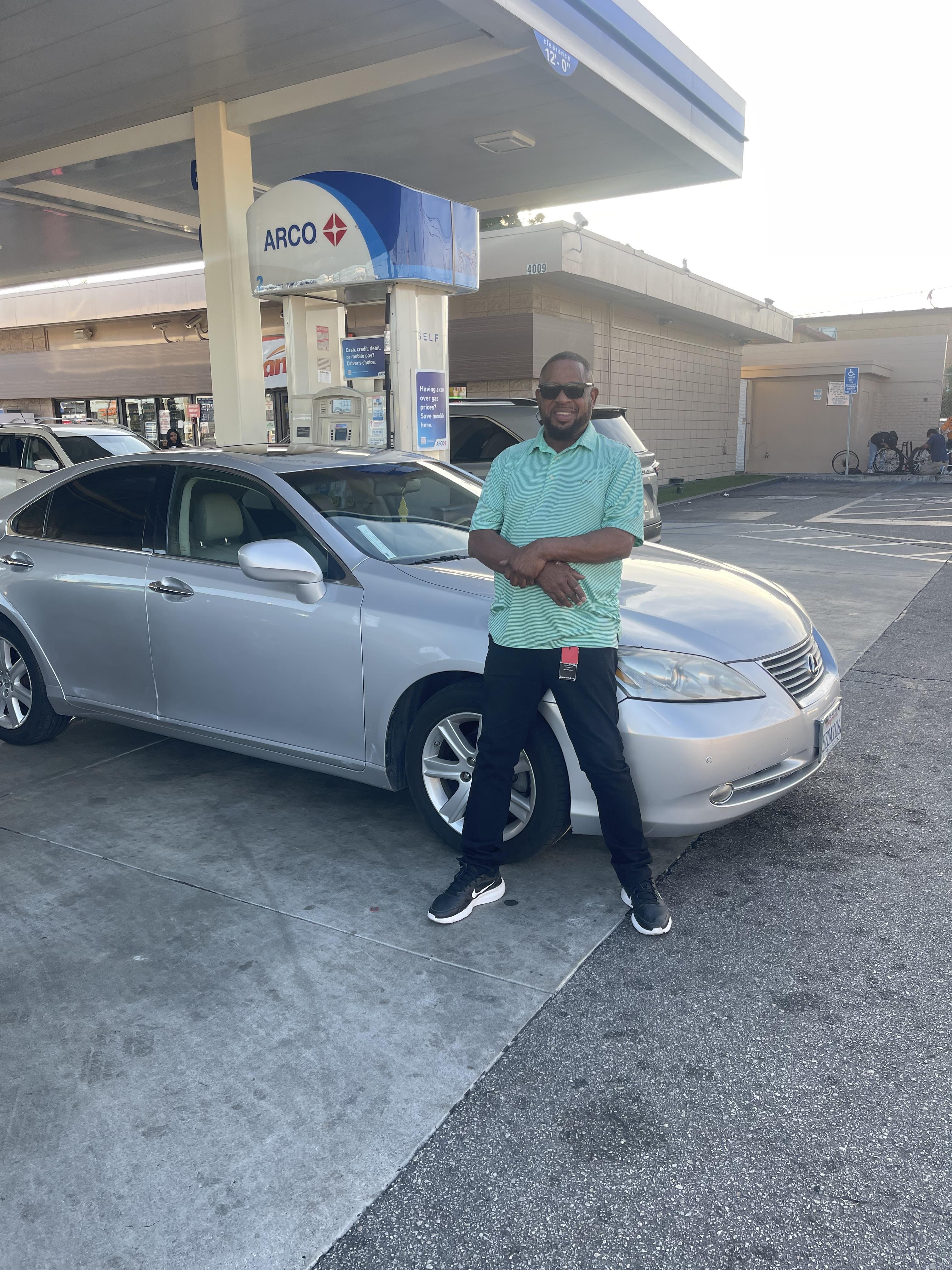 A man standing next to a car