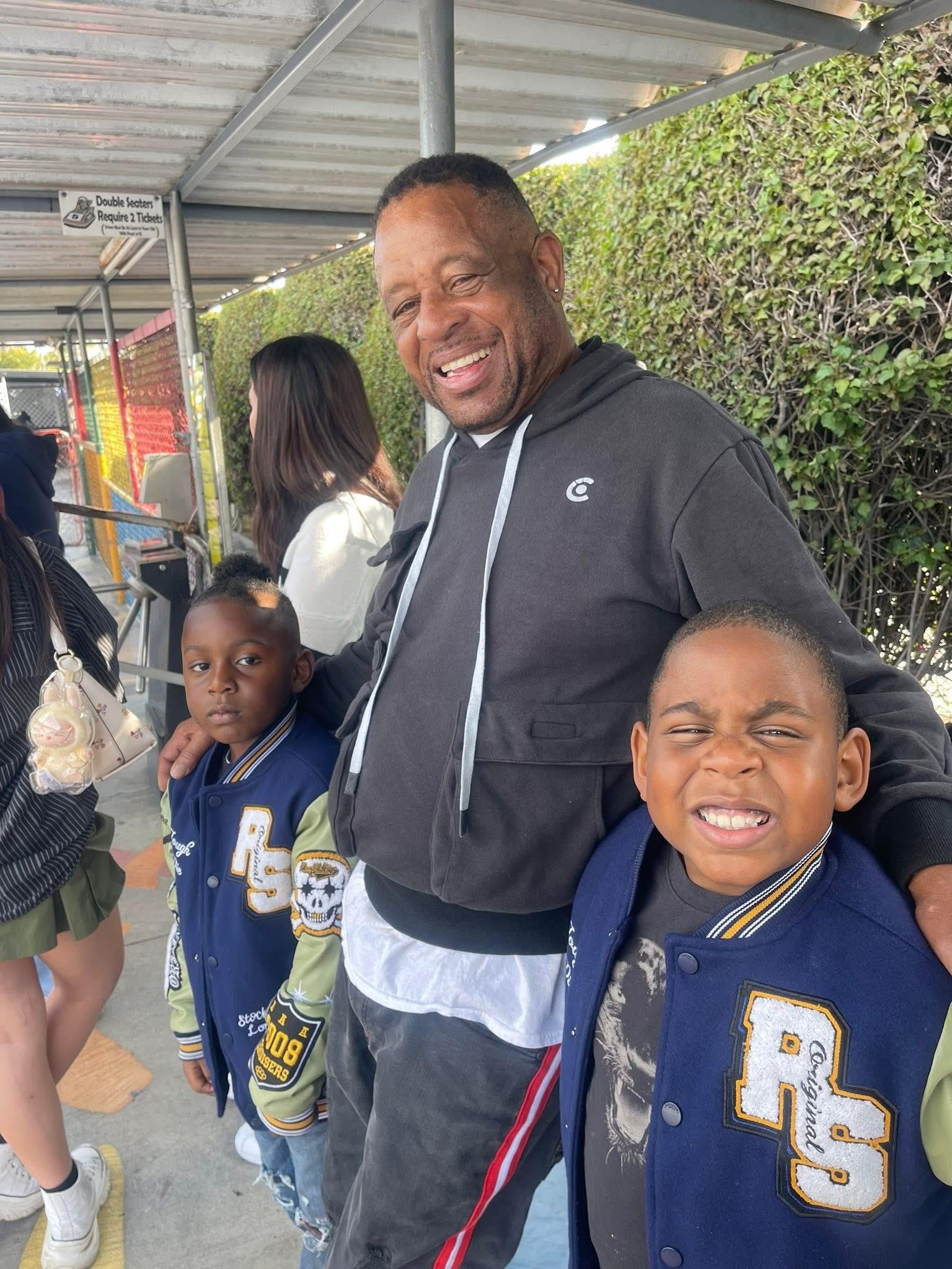 A man and two boys posing for a picture