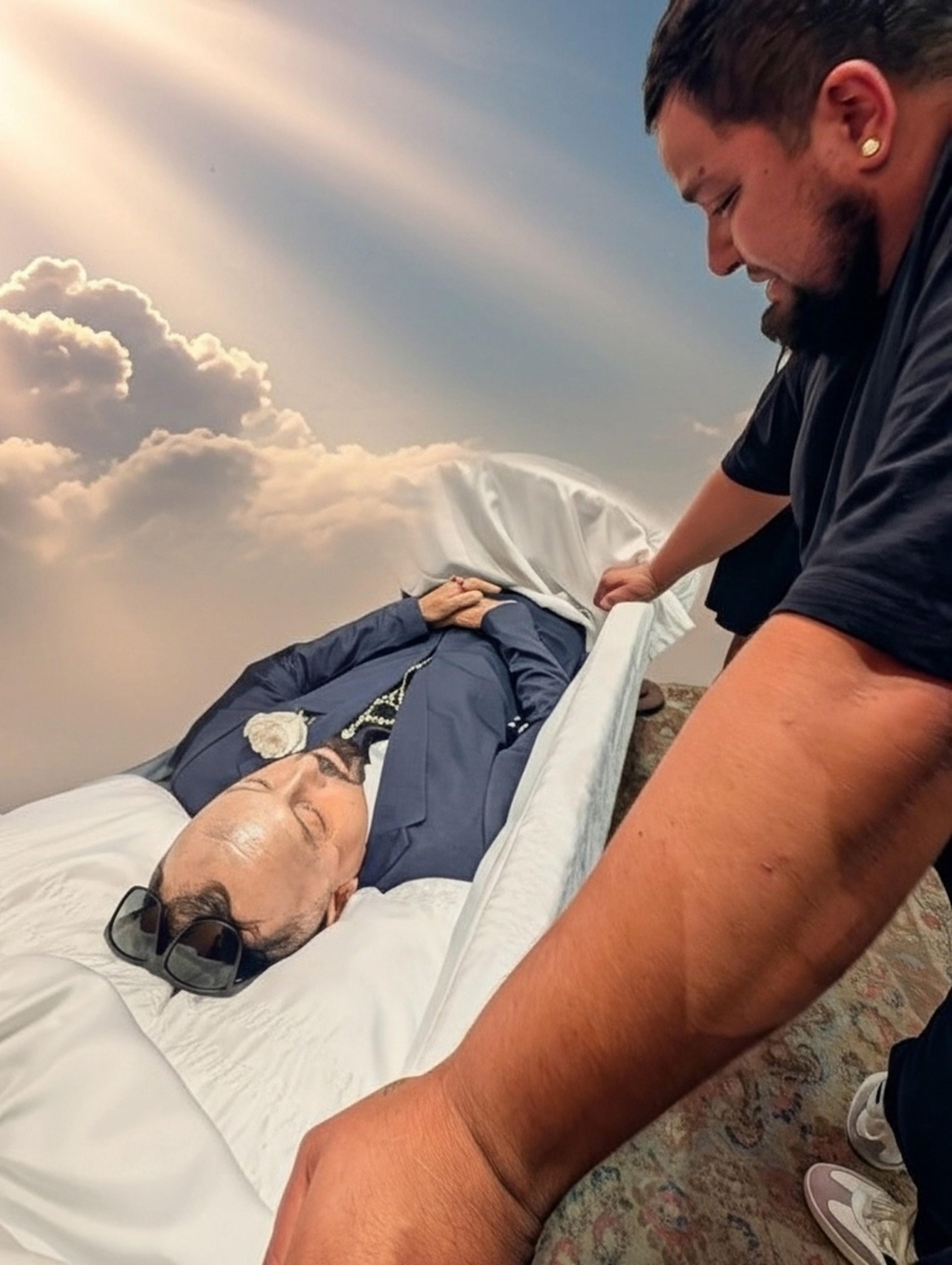 A man in a suit lying in a coffin