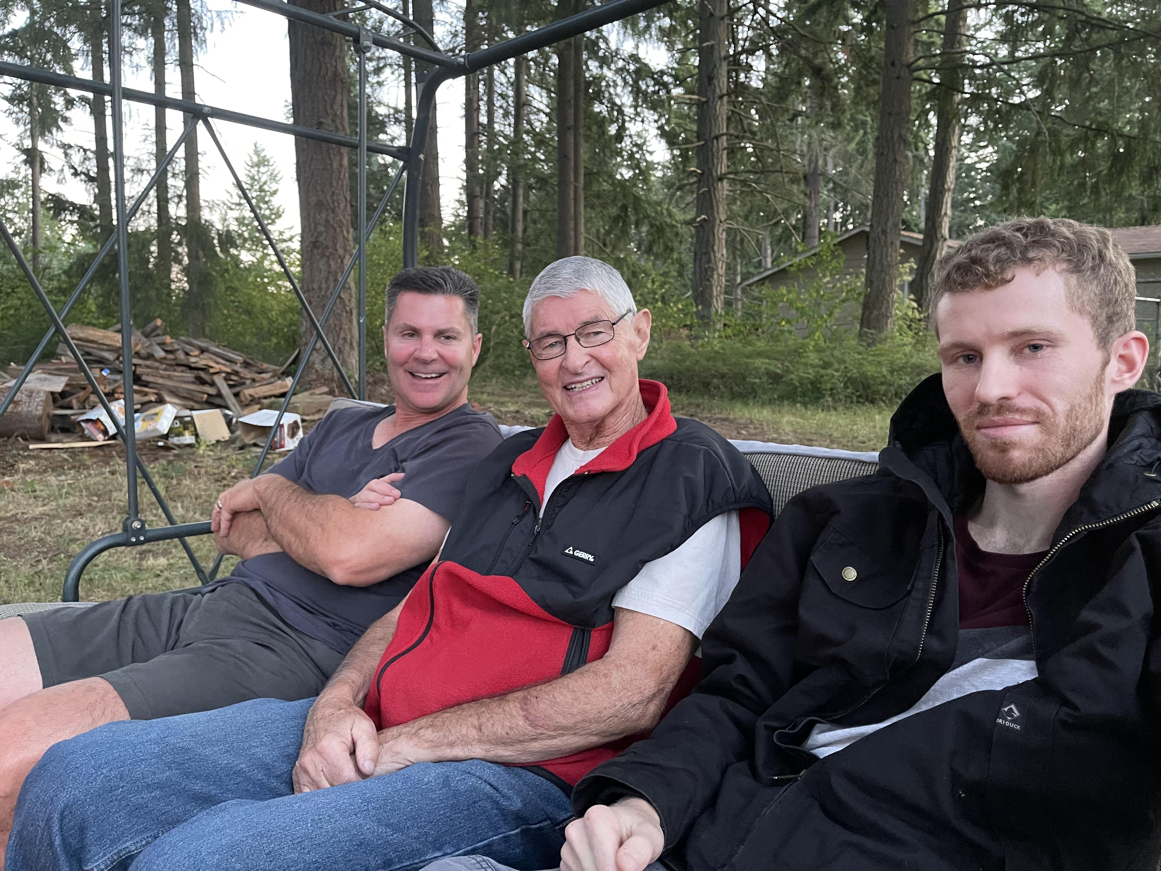 A group of men sitting on a swing
