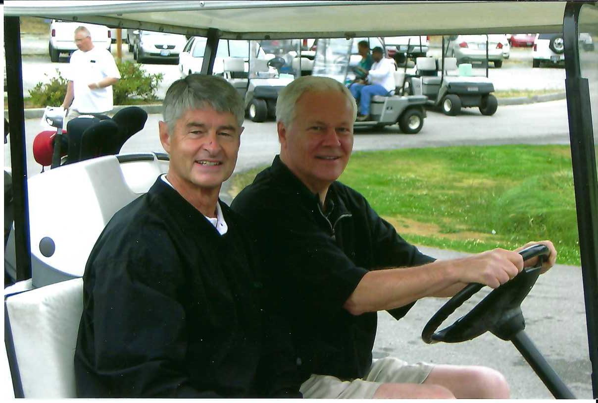A couple of men driving golf carts