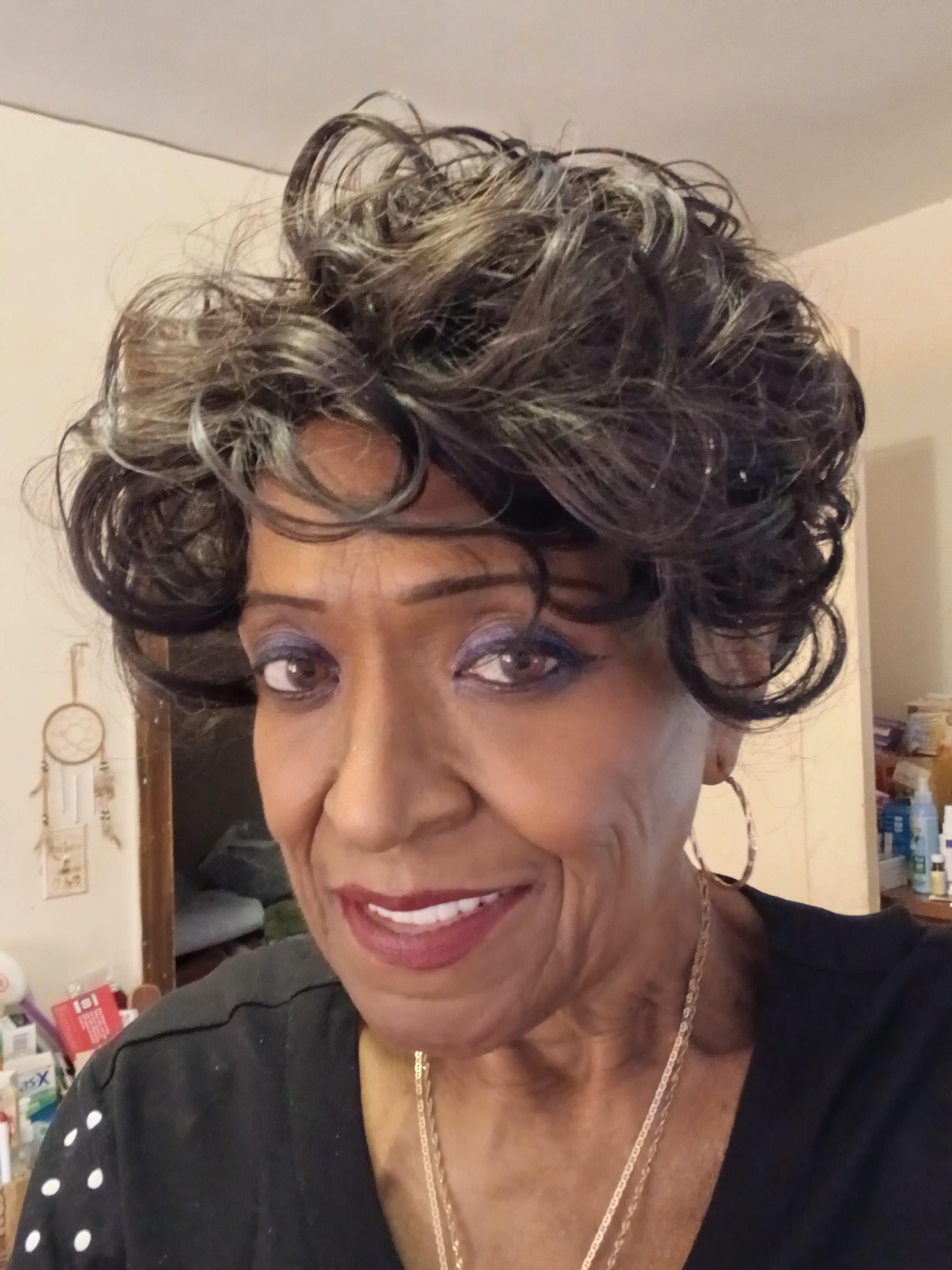 A woman with curly hair smiling