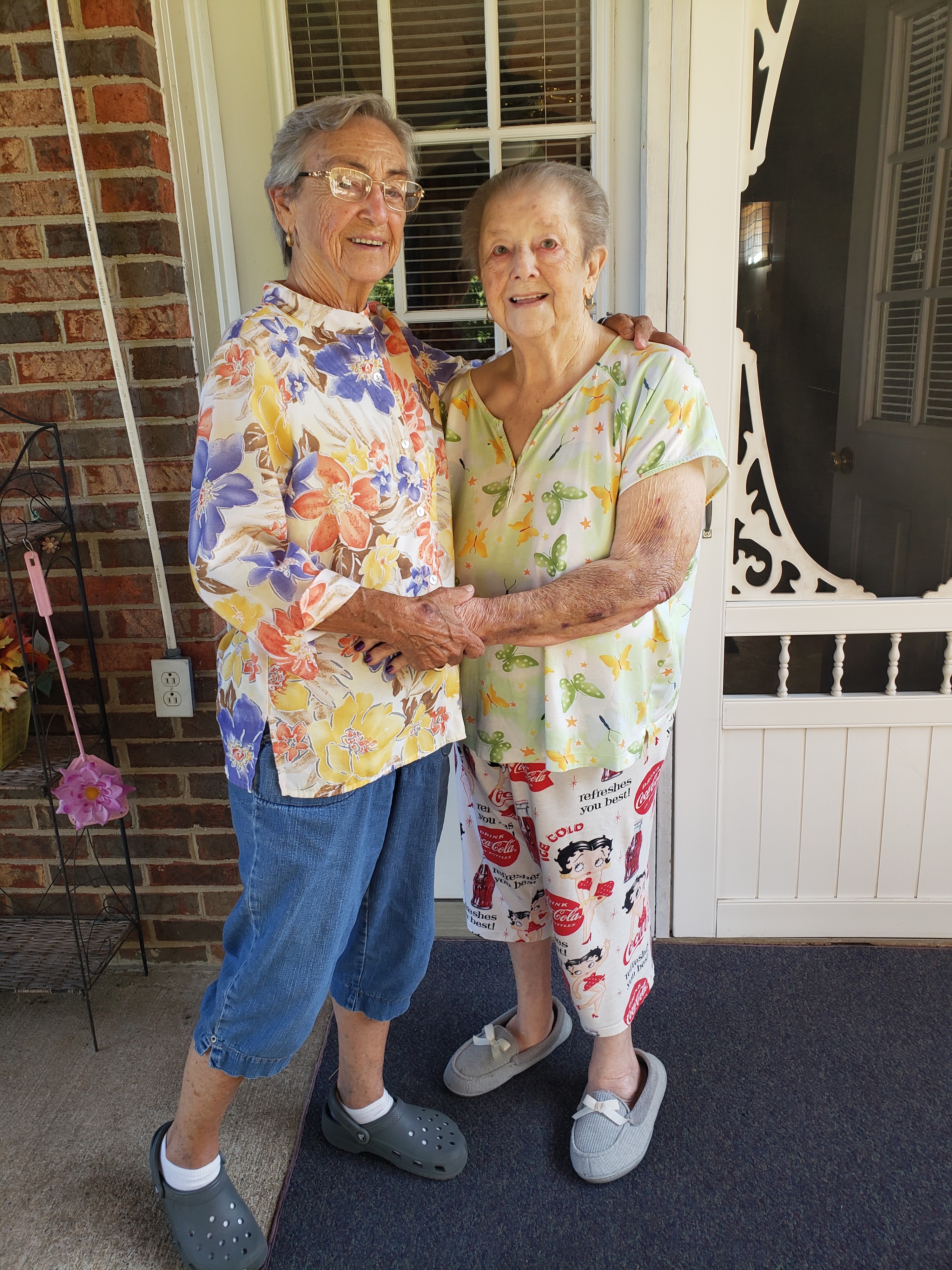 Two women standing in front of a door