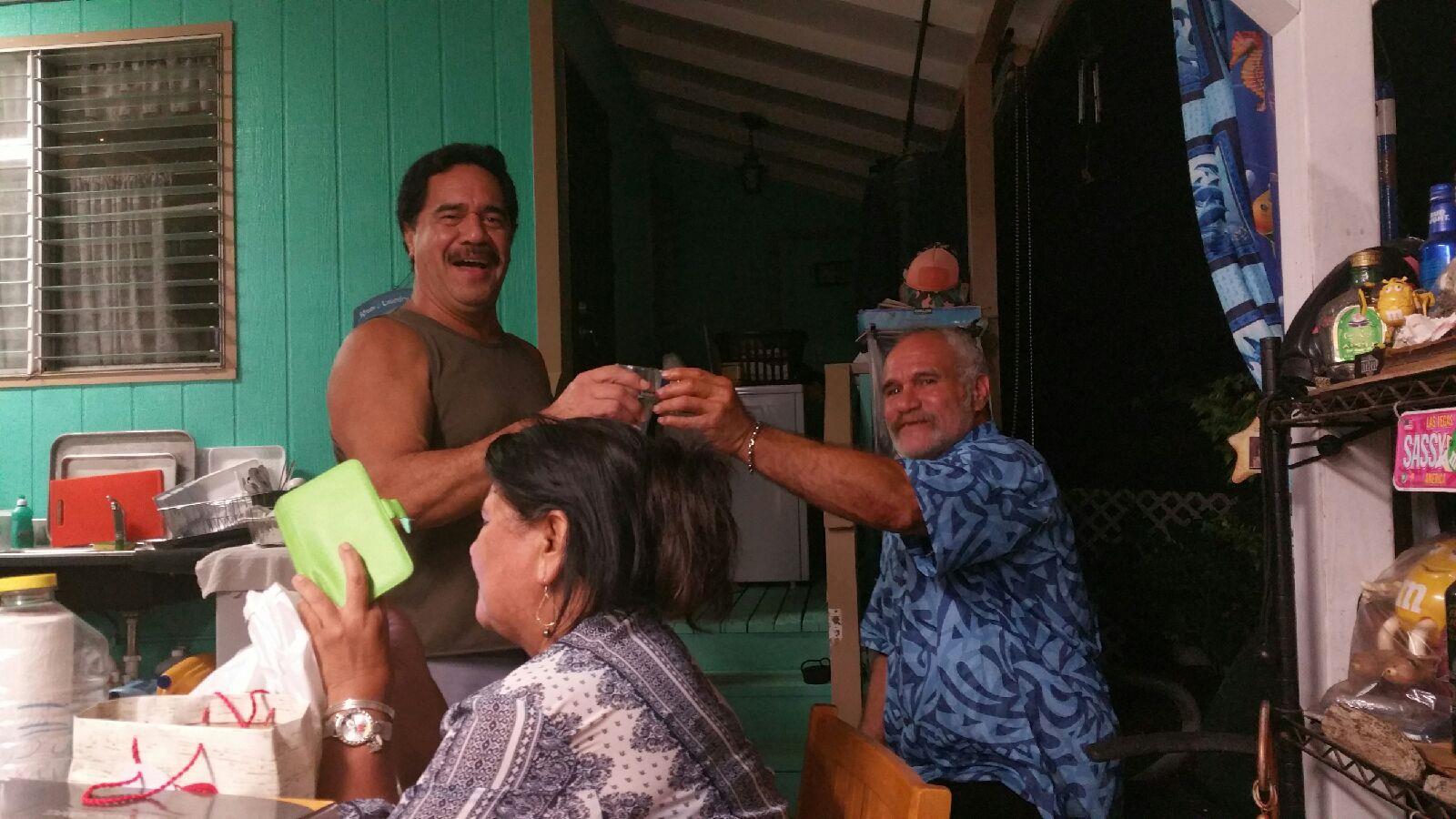 A man cutting a woman's hair