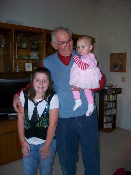 A man holding a baby and a girl