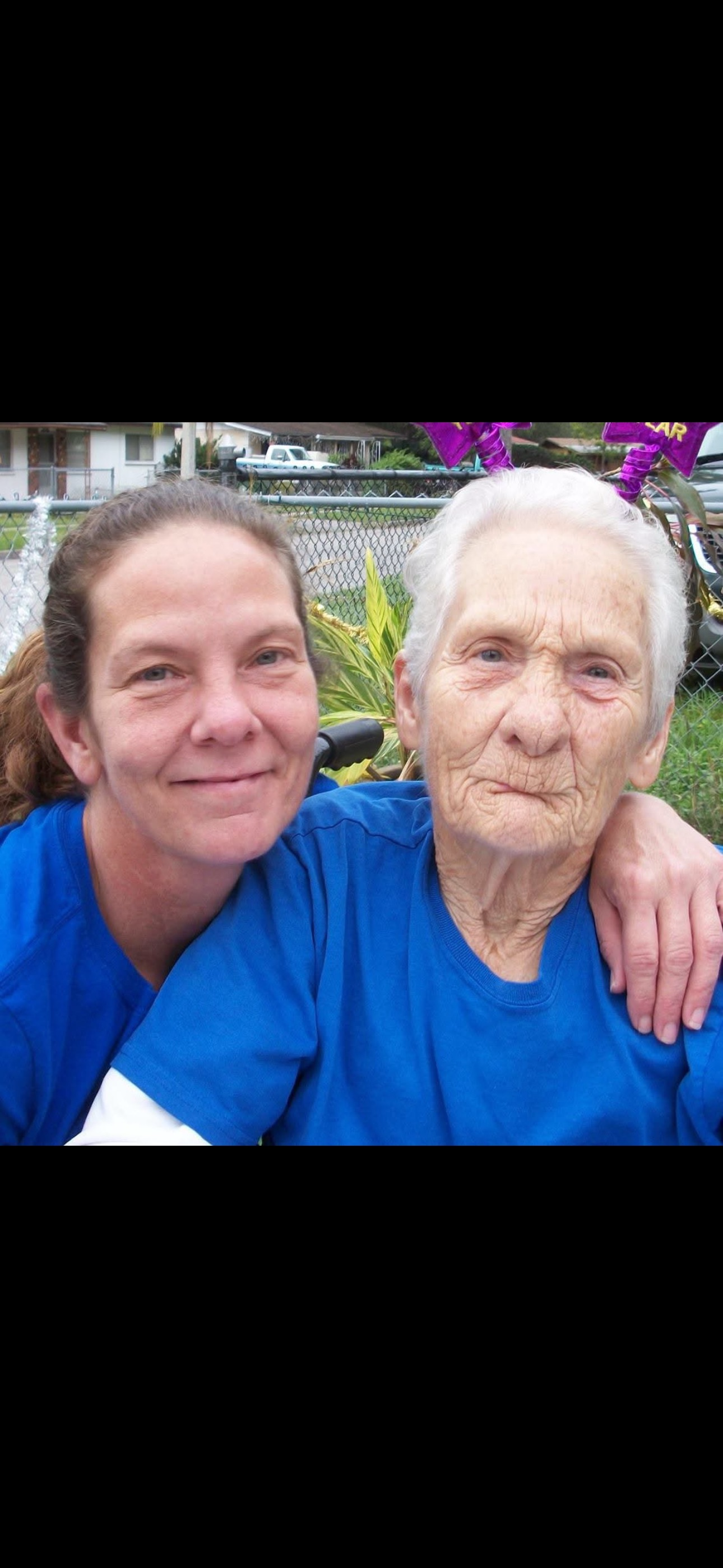 A woman and a young woman posing for a picture