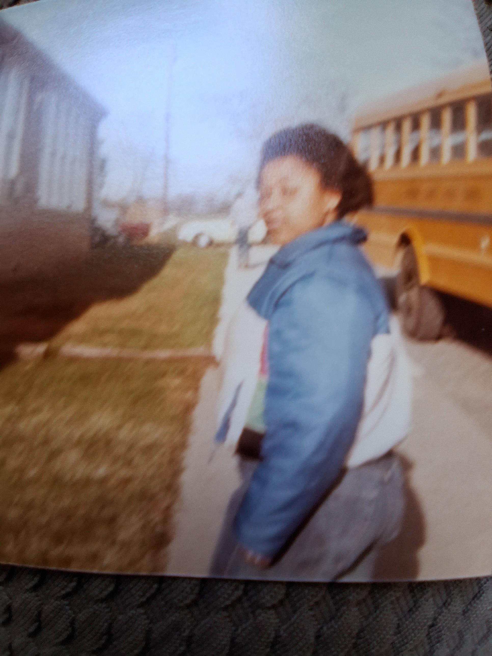 A blurry image of a woman walking on a sidewalk