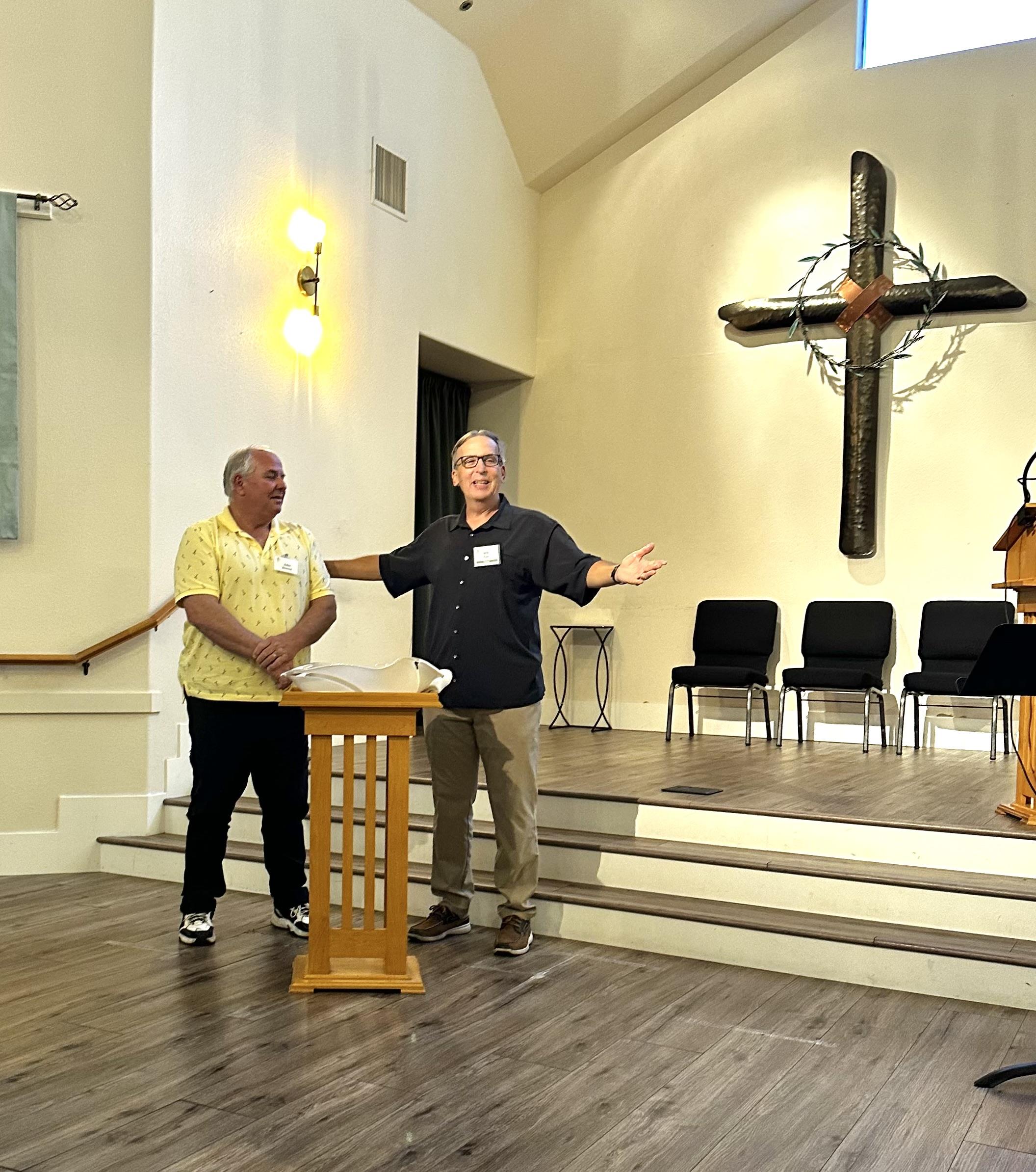 A man standing in front of a podium with his arms out