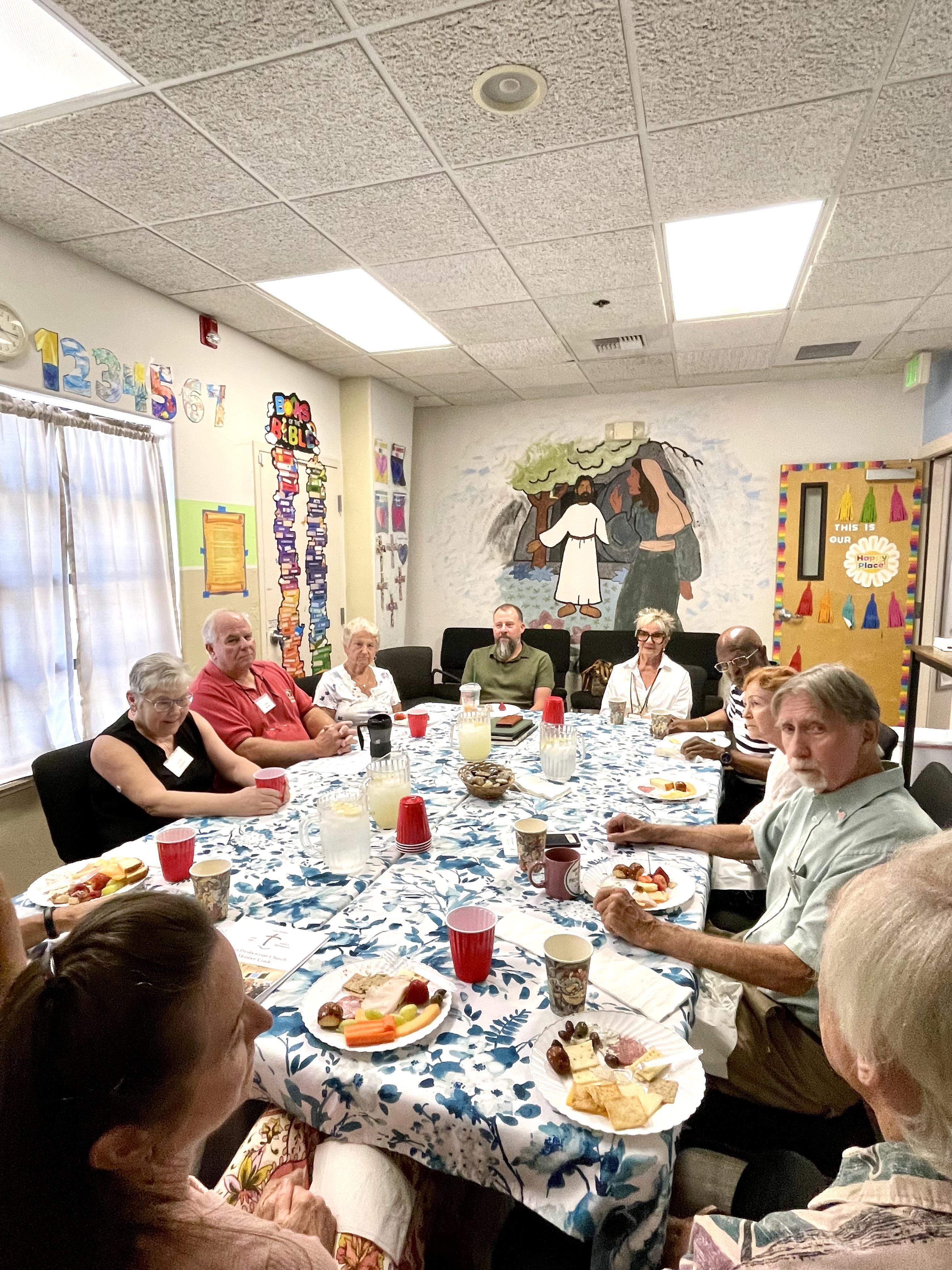 A group of people sitting around a table