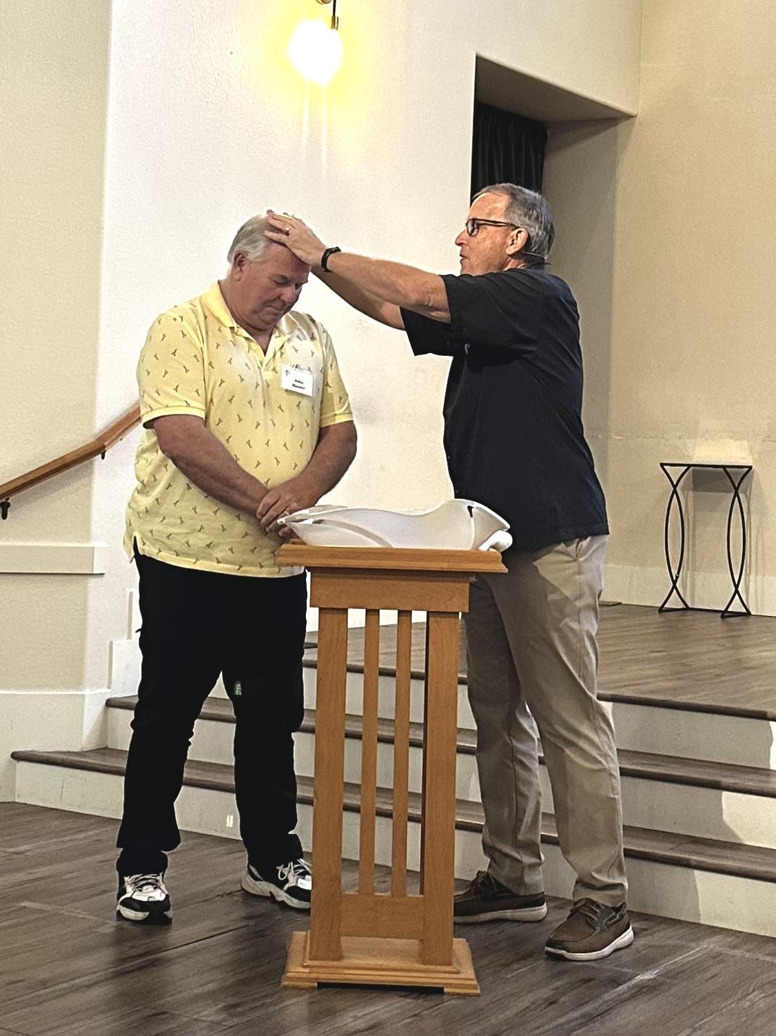 A man standing next to another man