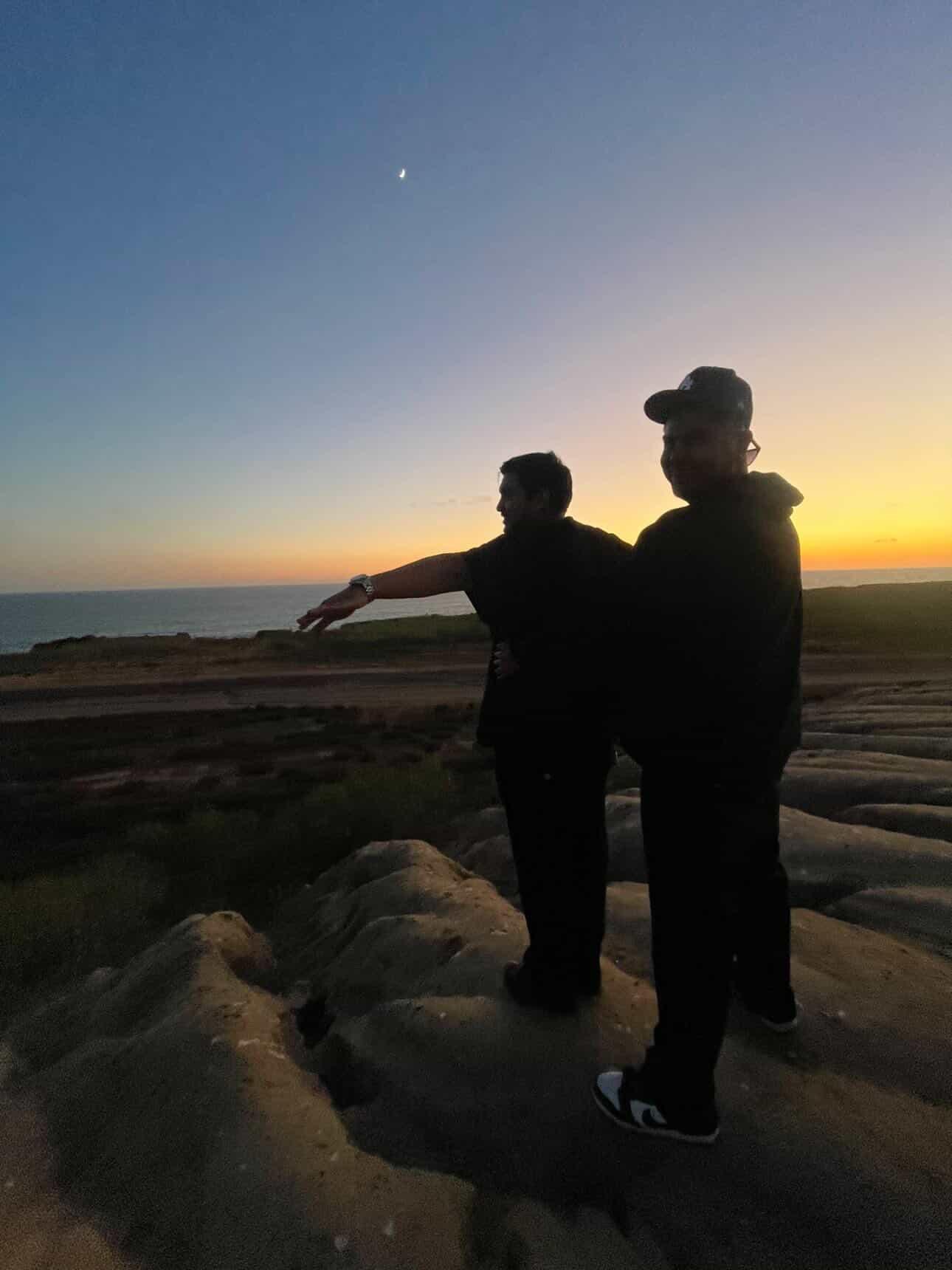 Two people standing on a rock