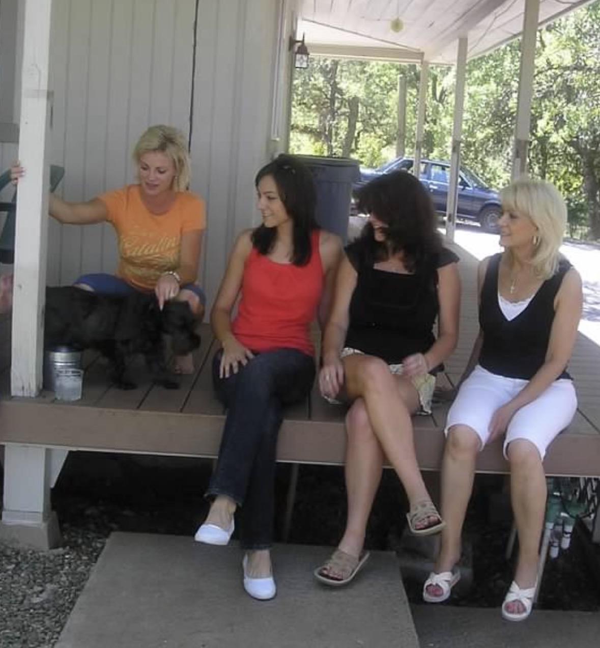 A group of women sitting on a porch