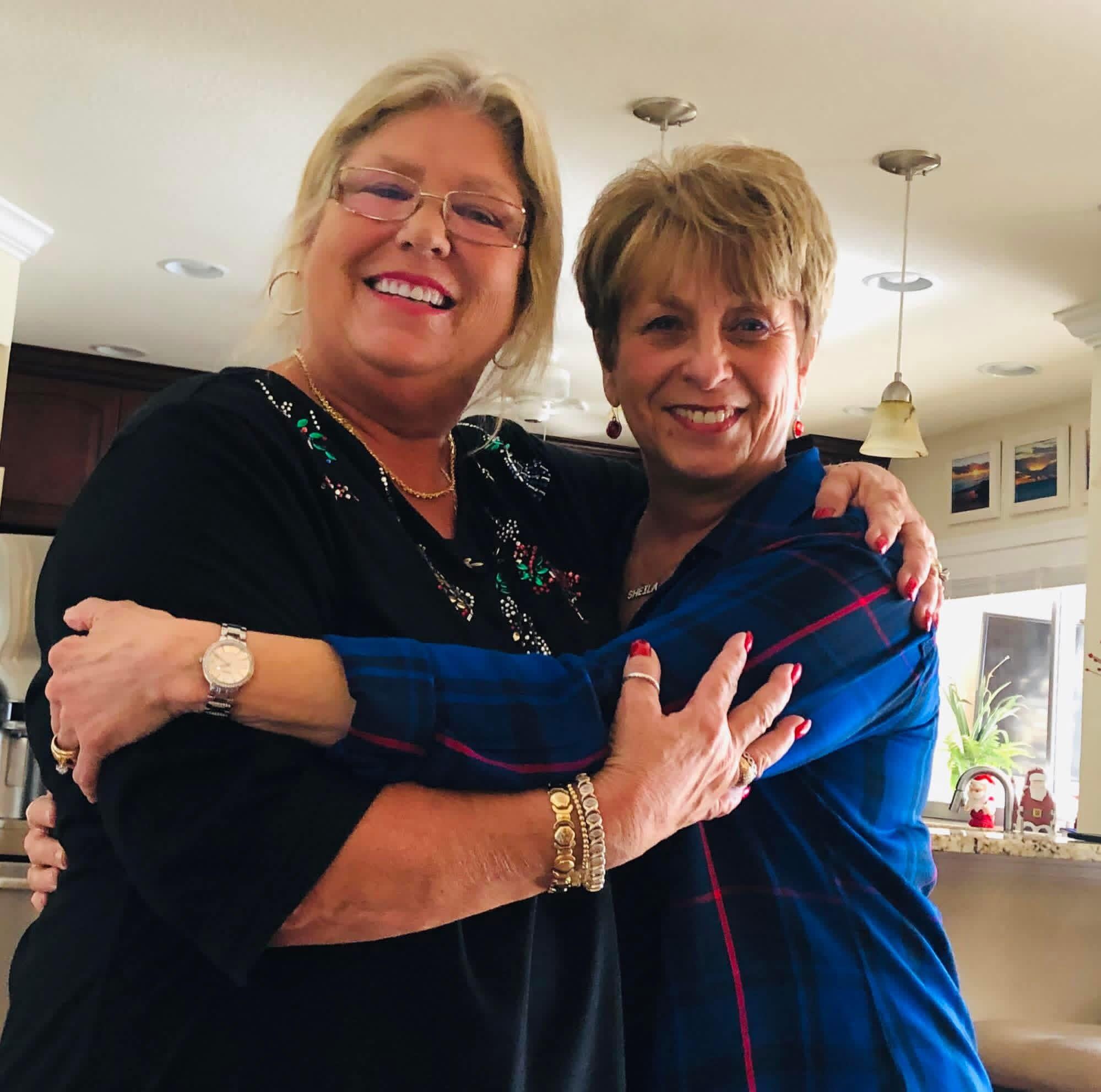 Two women hugging each other