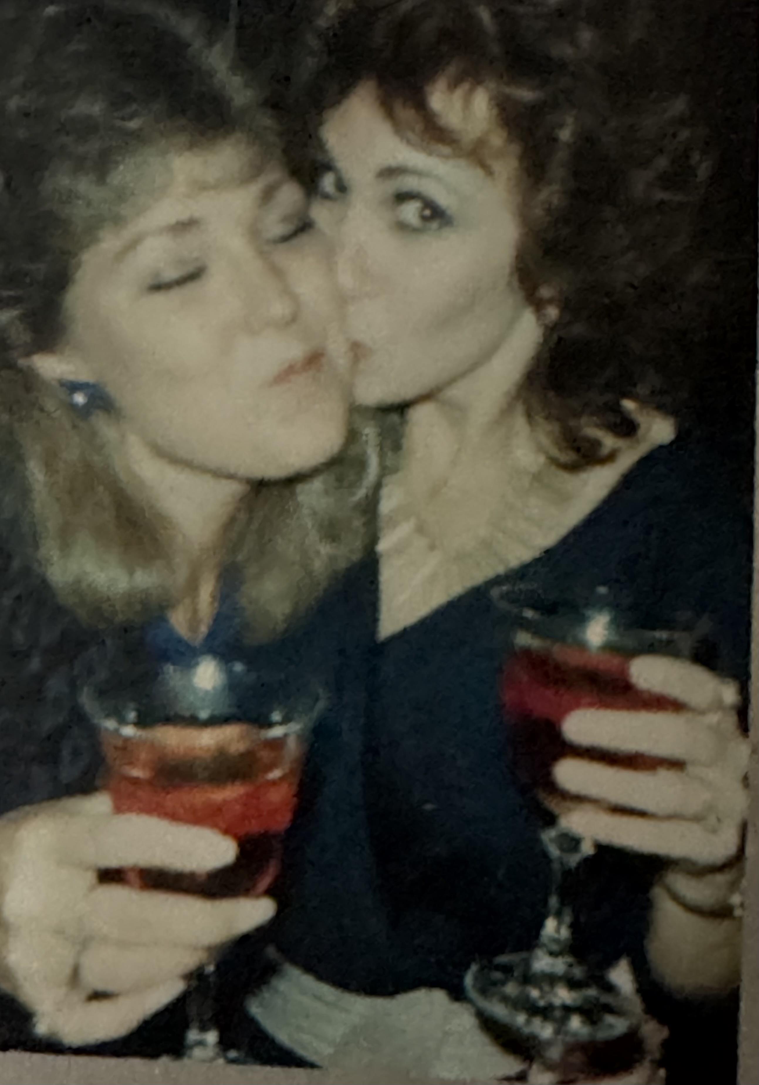 A couple of women holding drinks