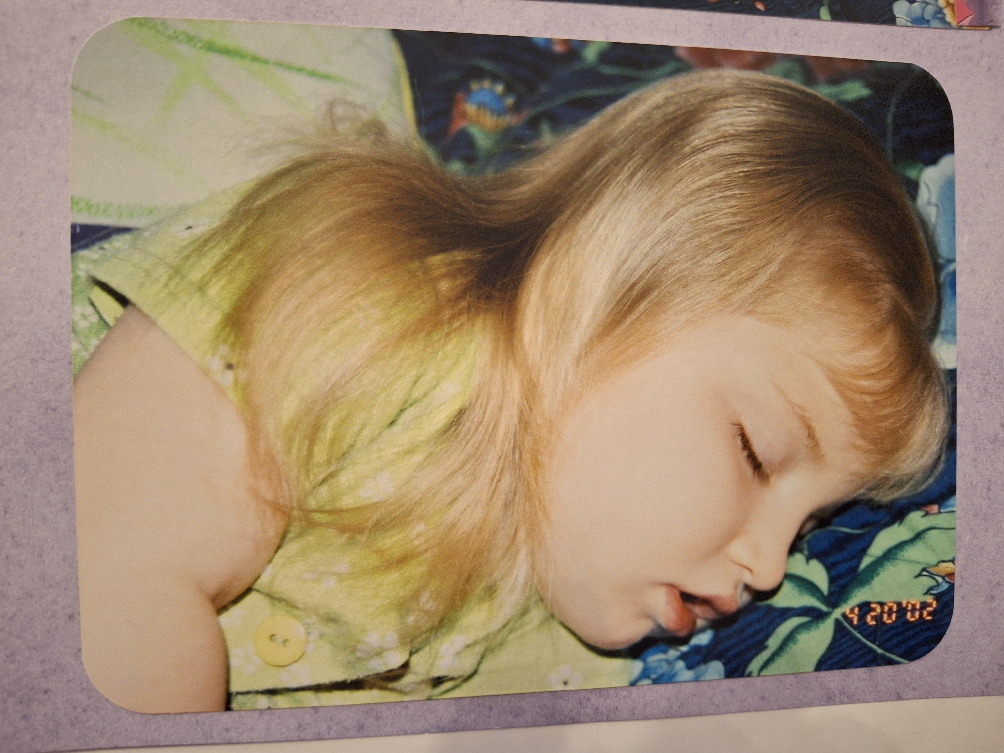 A child sleeping on a bed