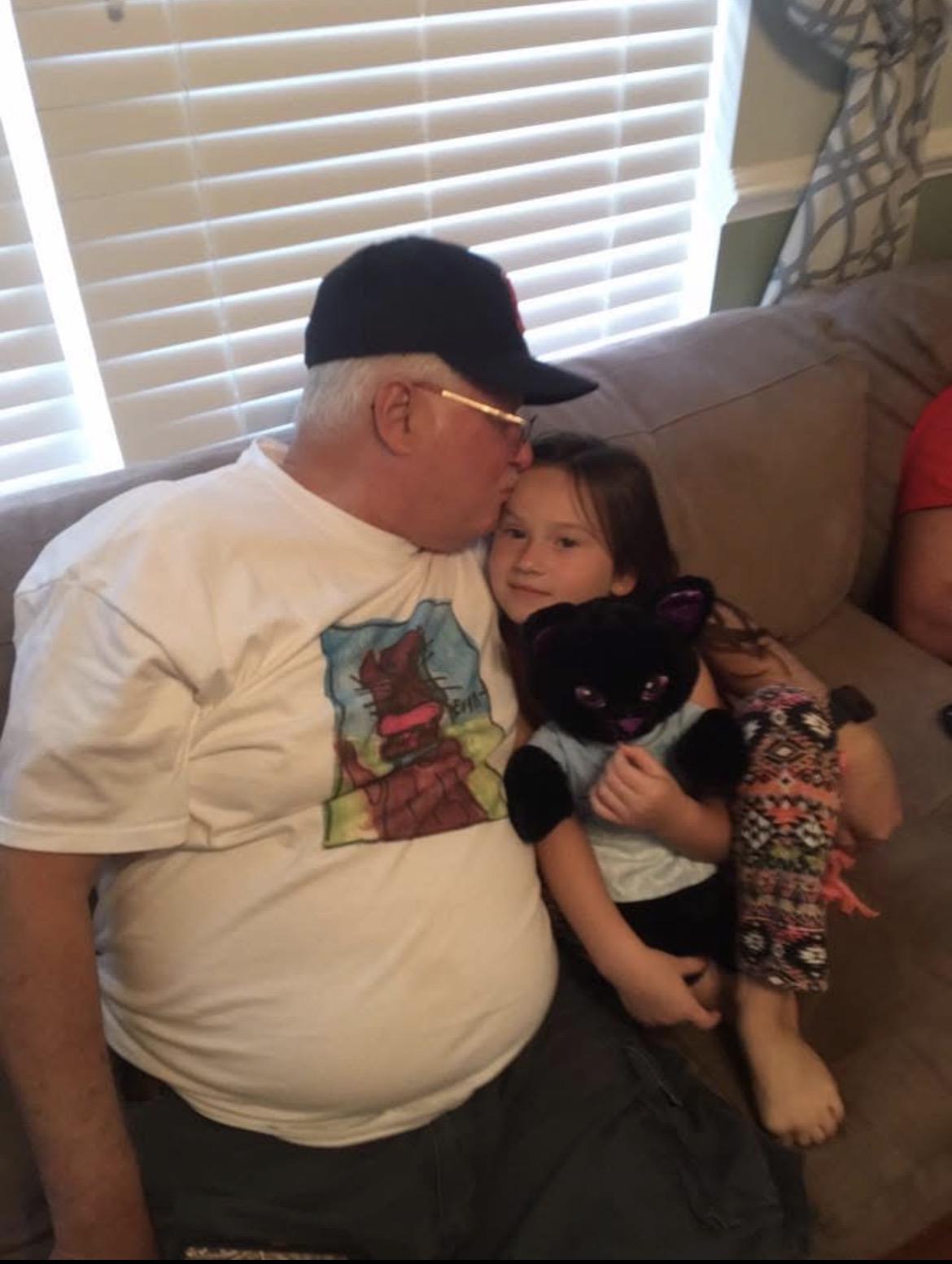A man and girl sitting on a couch