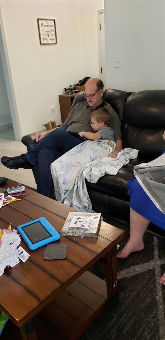A man and a child sitting on a couch