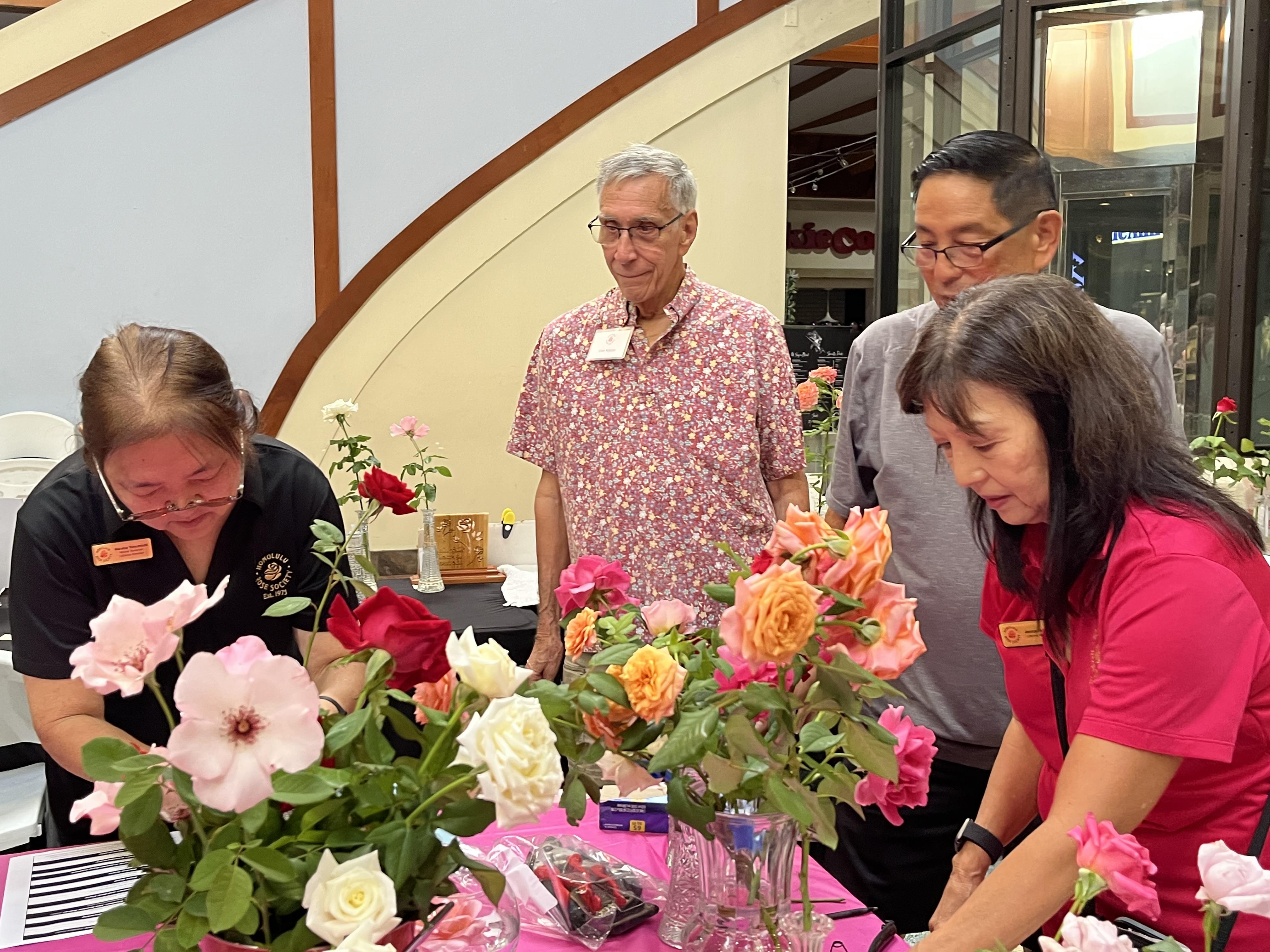 A group of people looking at flowers