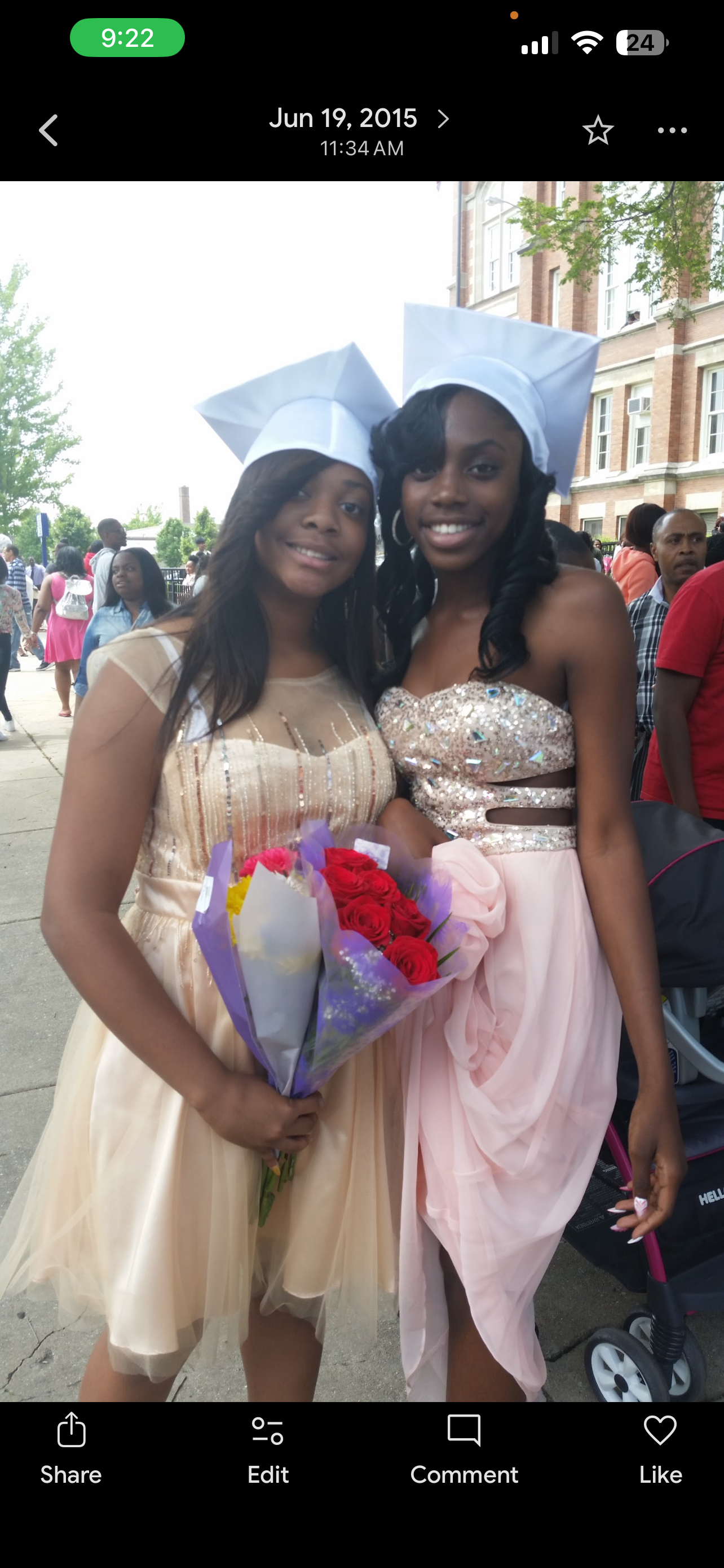 Two women wearing dresses and holding flowers