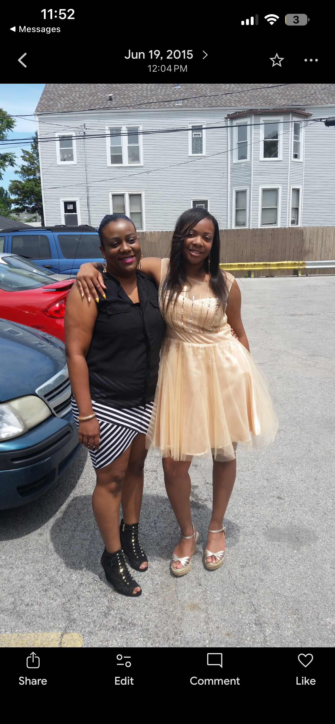 Two women standing in front of a car