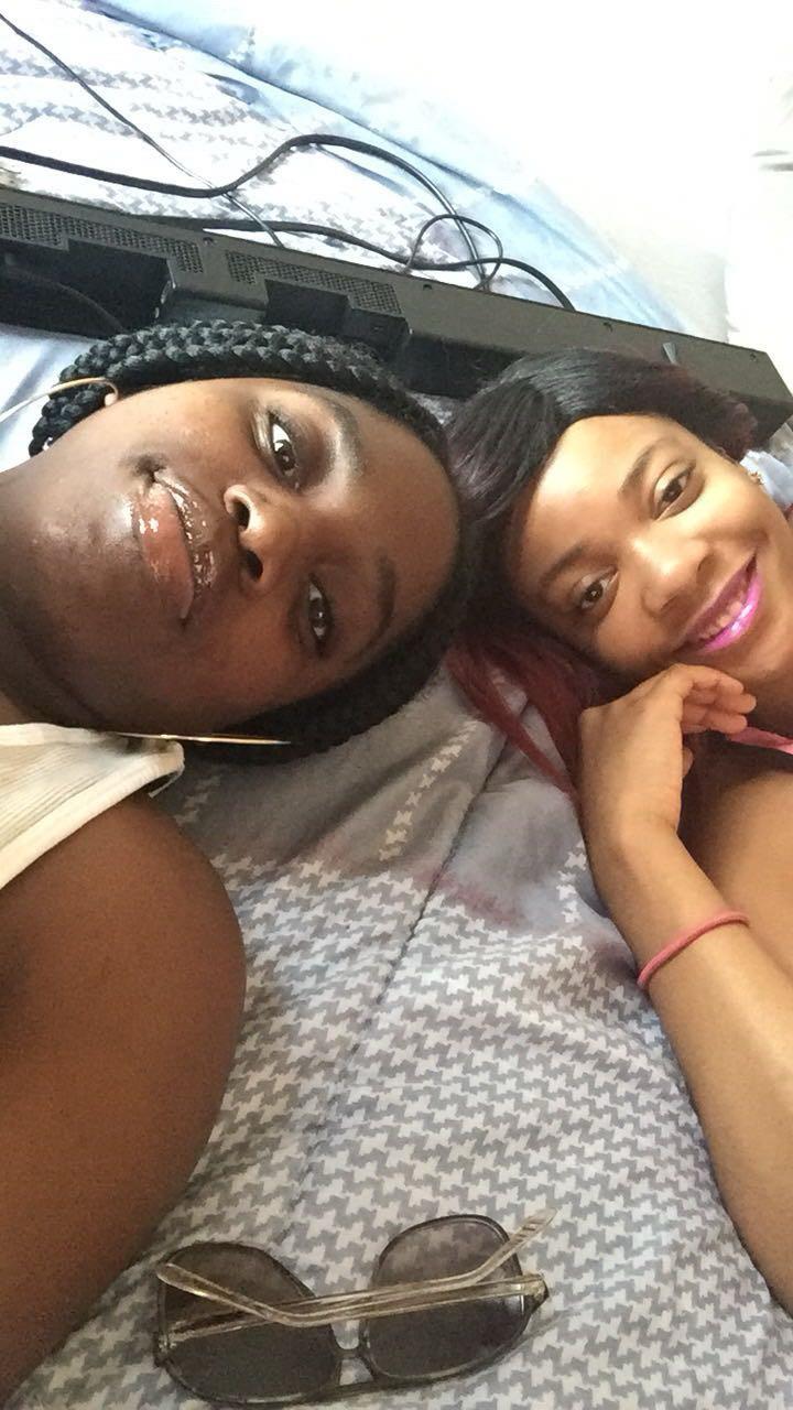 Two women lying on a bed