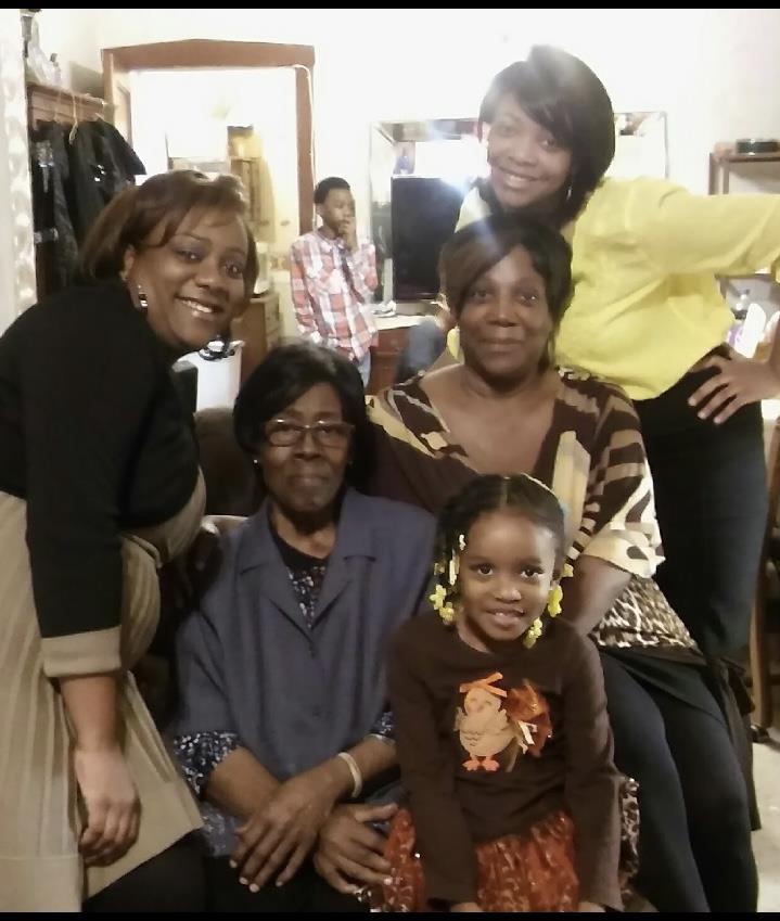 A group of women and a child posing for a photo