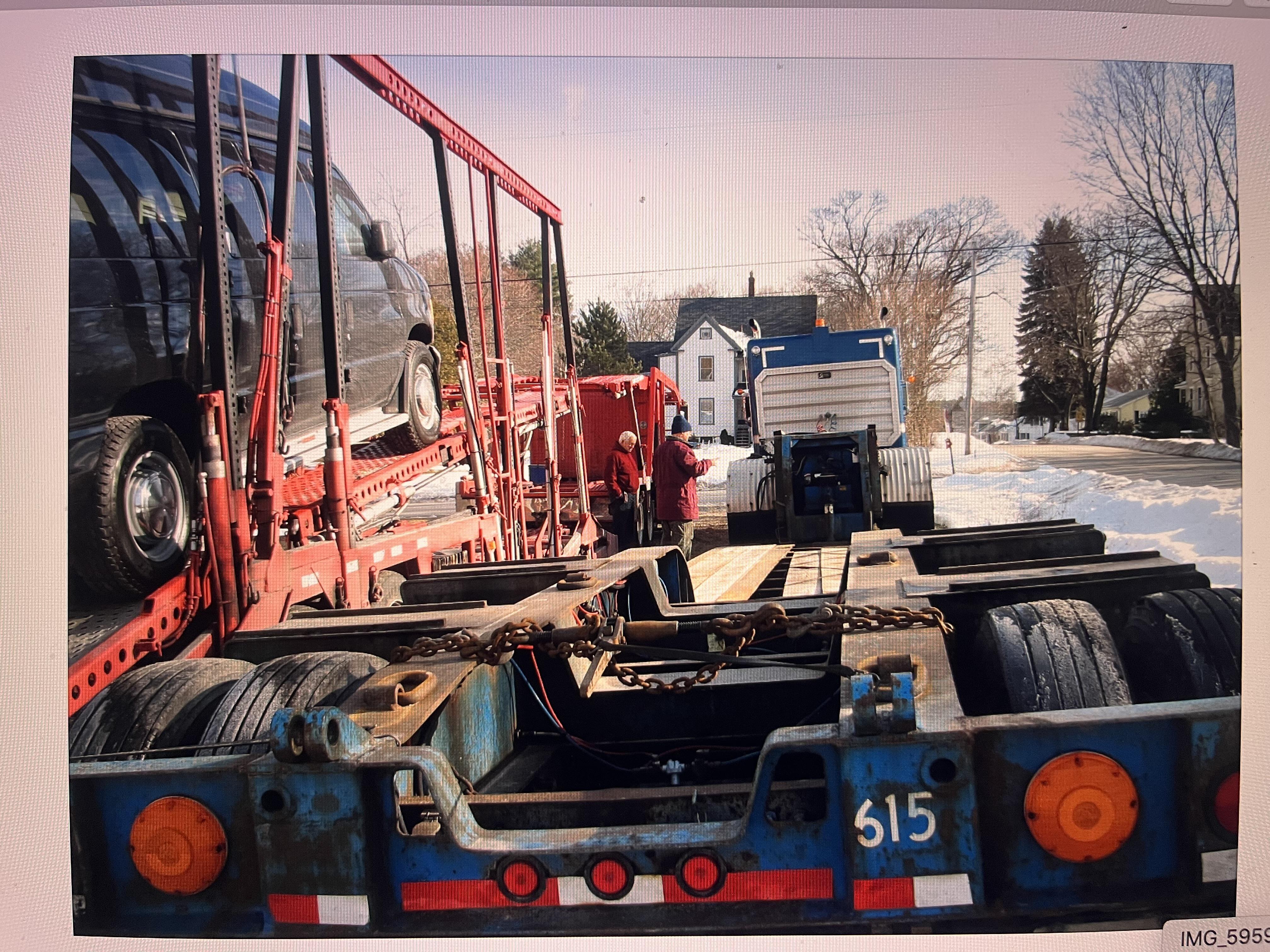 A truck with a trailer being loaded
