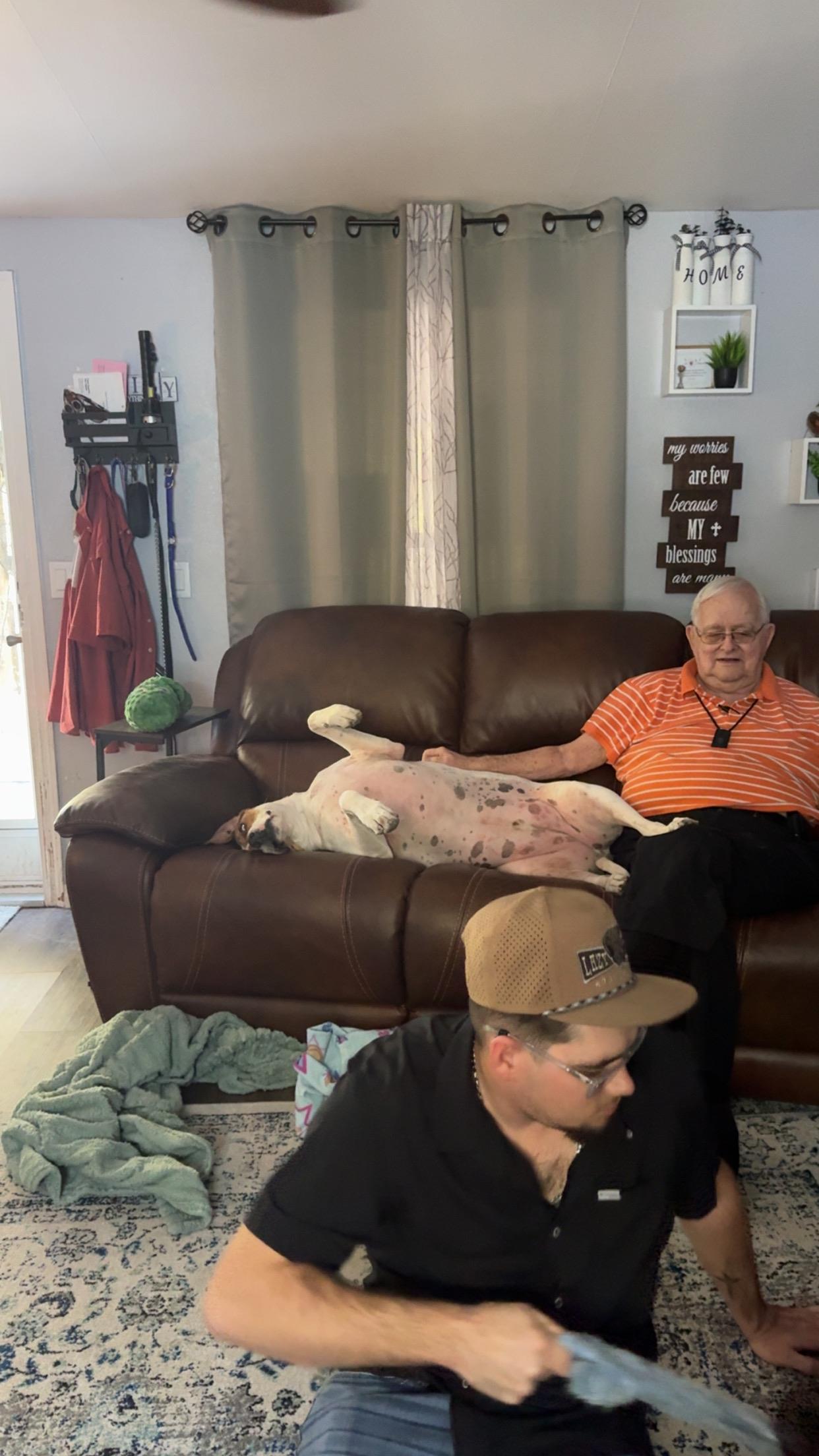 A man lying on a couch with a dog