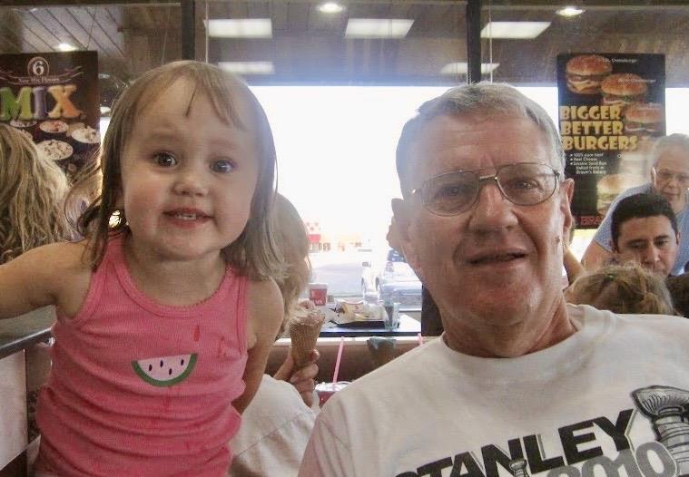 A man and a little girl posing for a picture