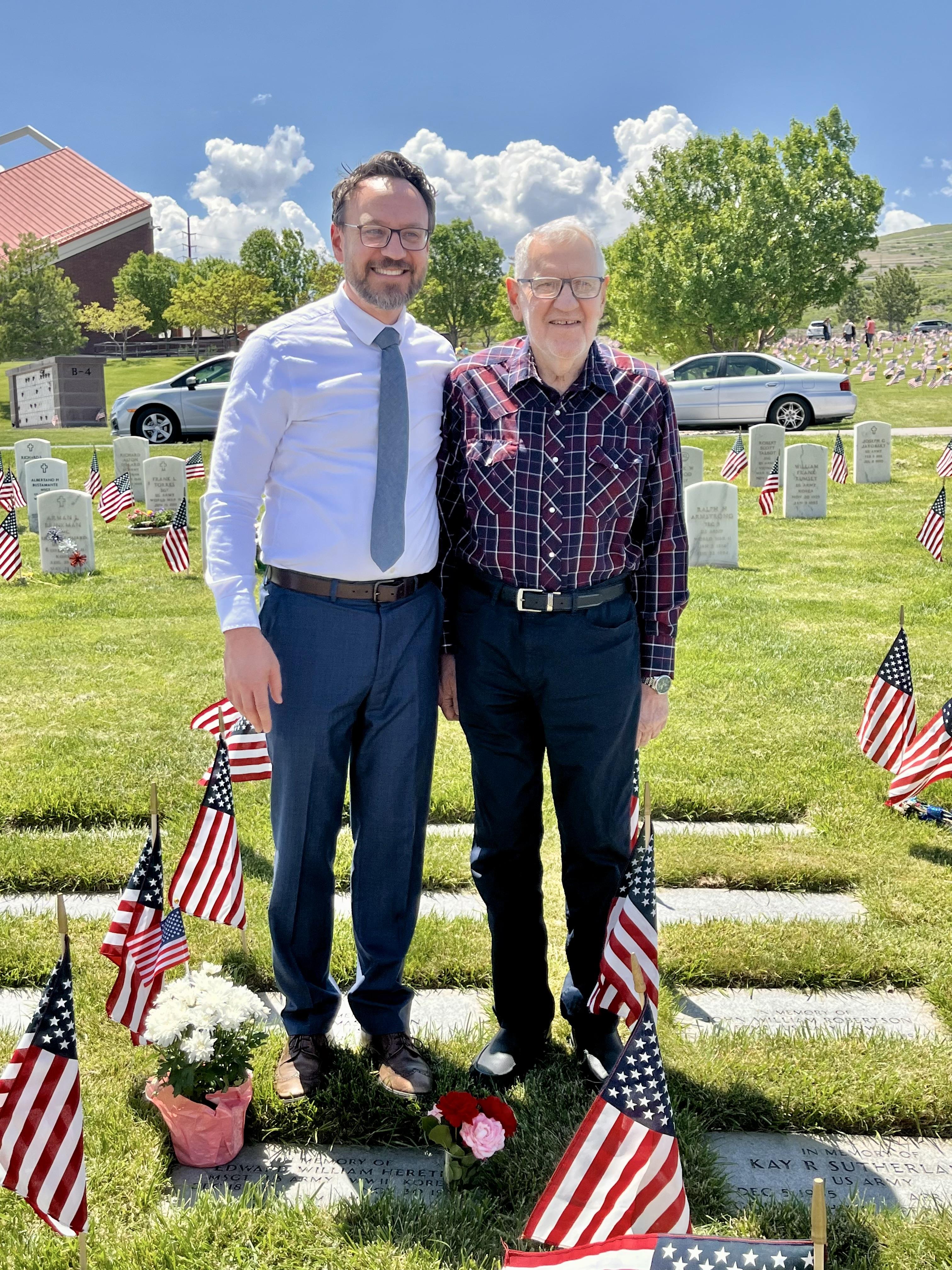 Two men standing in a cemetery