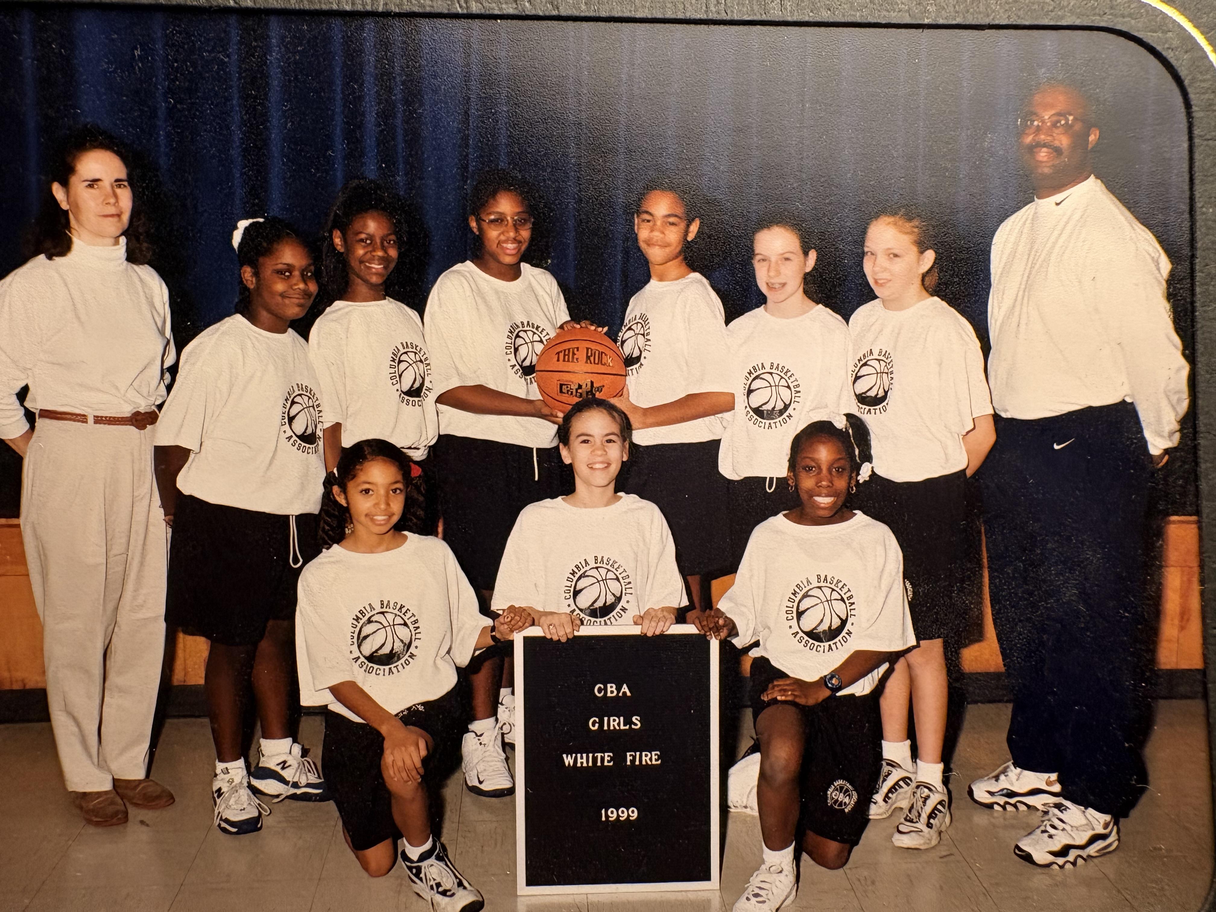 A group of girls basketball players posing for a photo