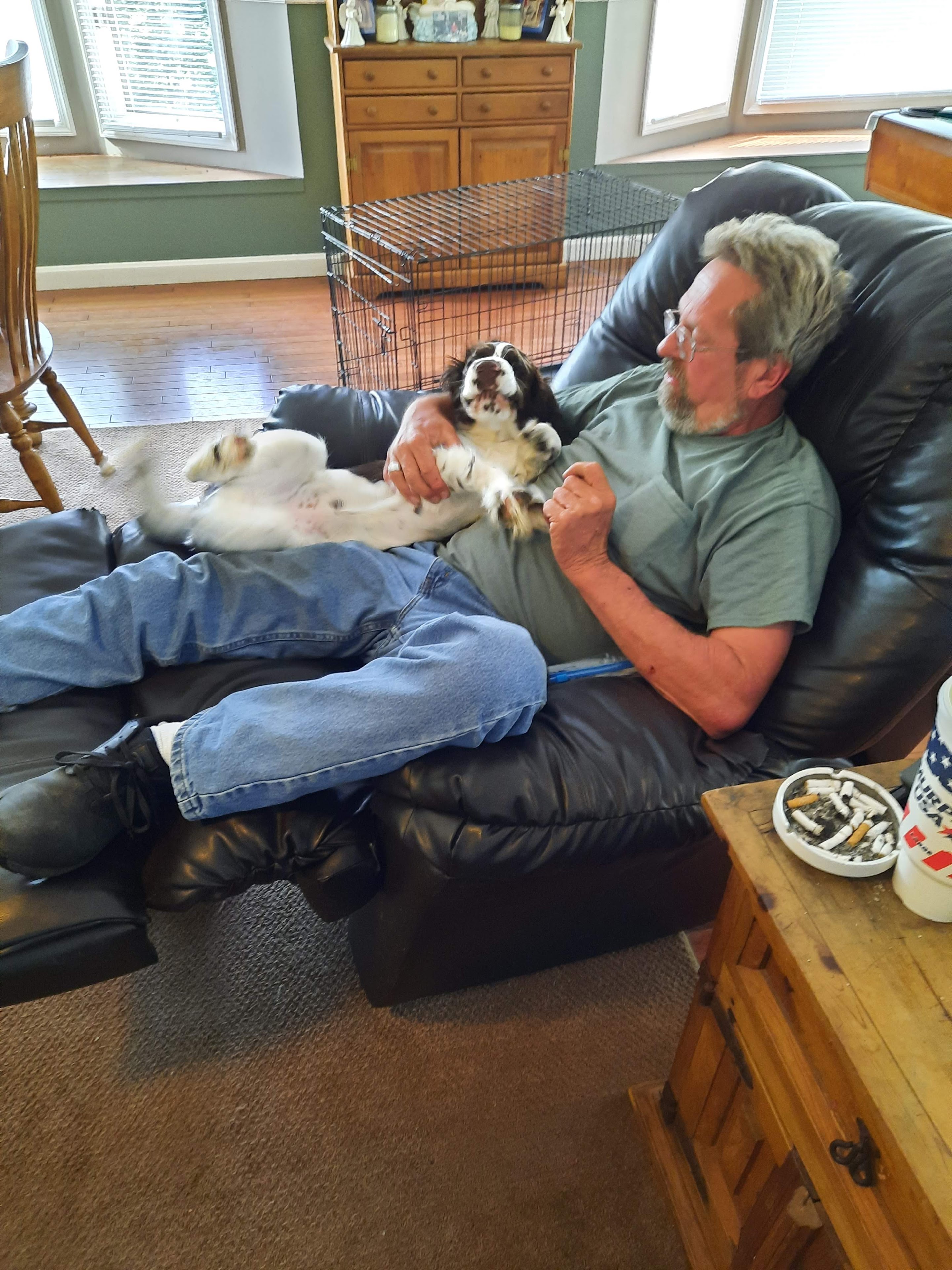 A man lying on a couch with a dog