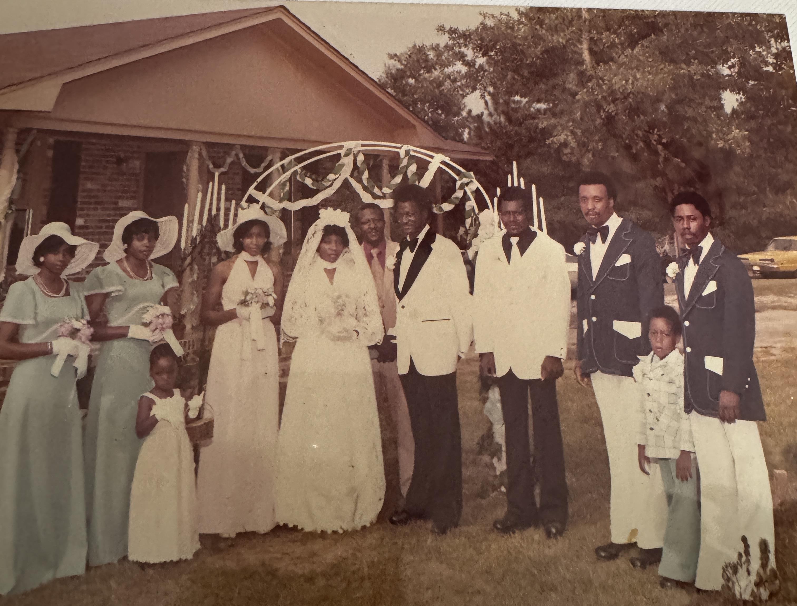 A group of people standing outside a house