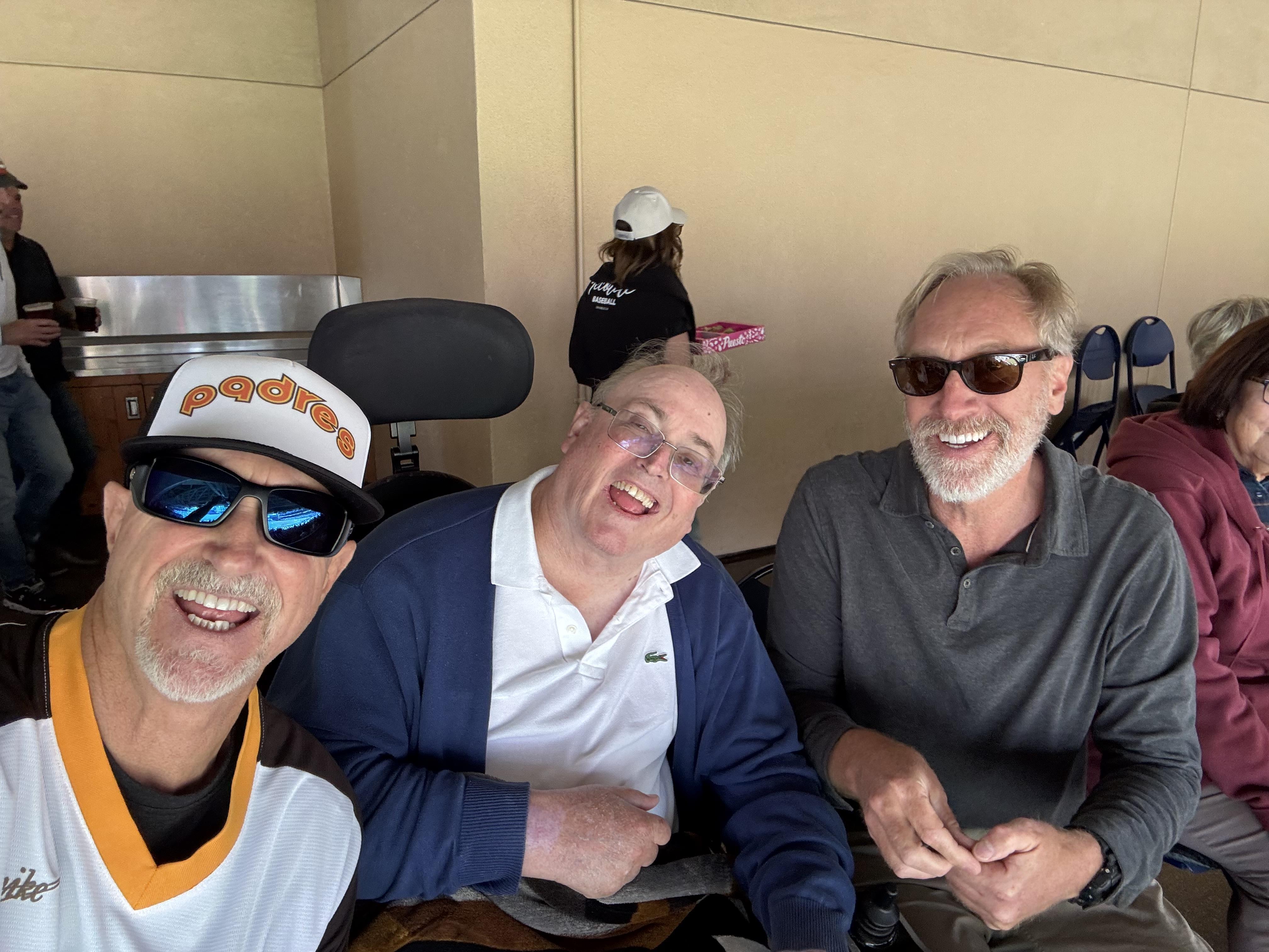 A group of men sitting in chairs smiling