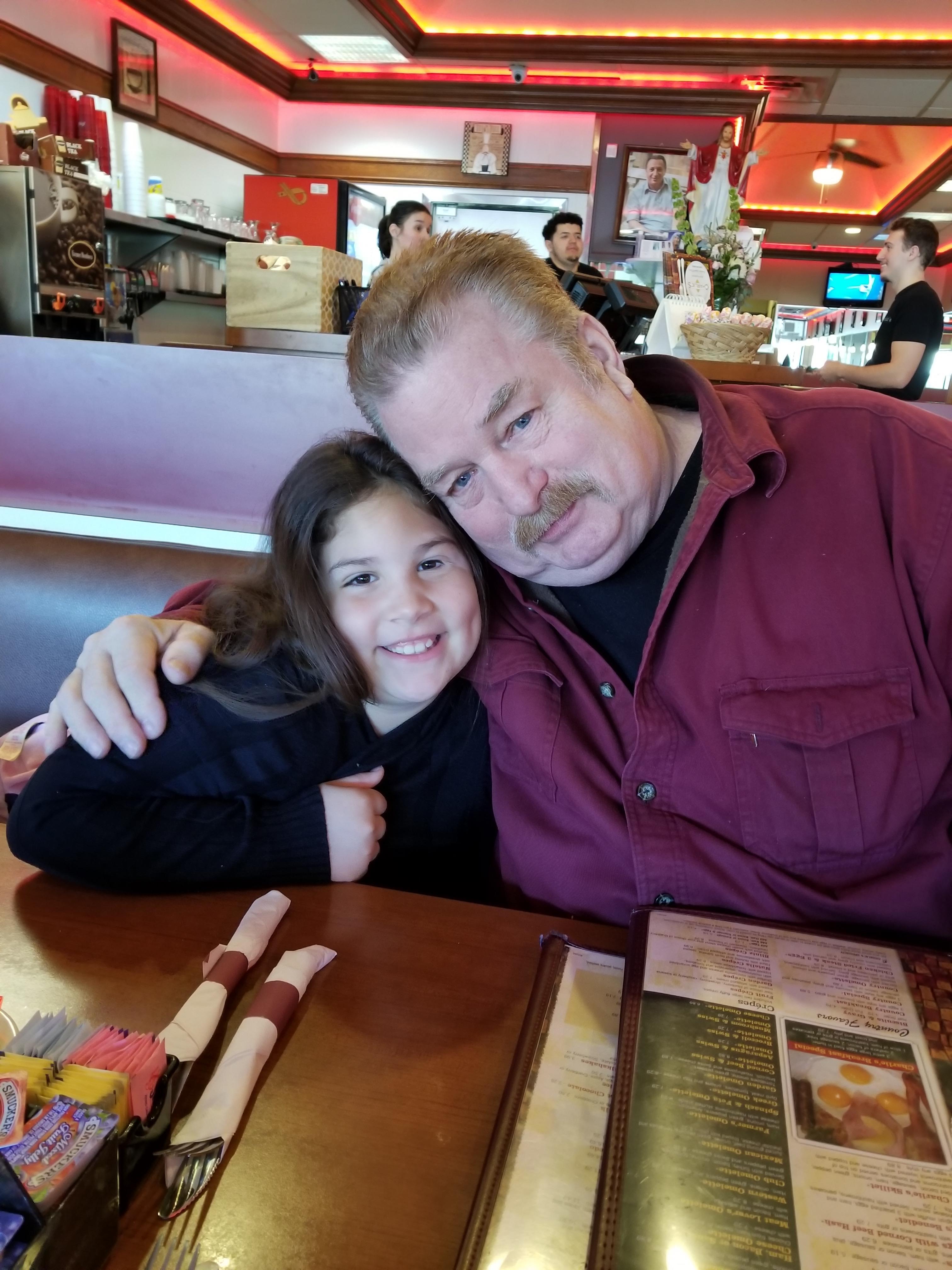 A man and a girl sitting at a table