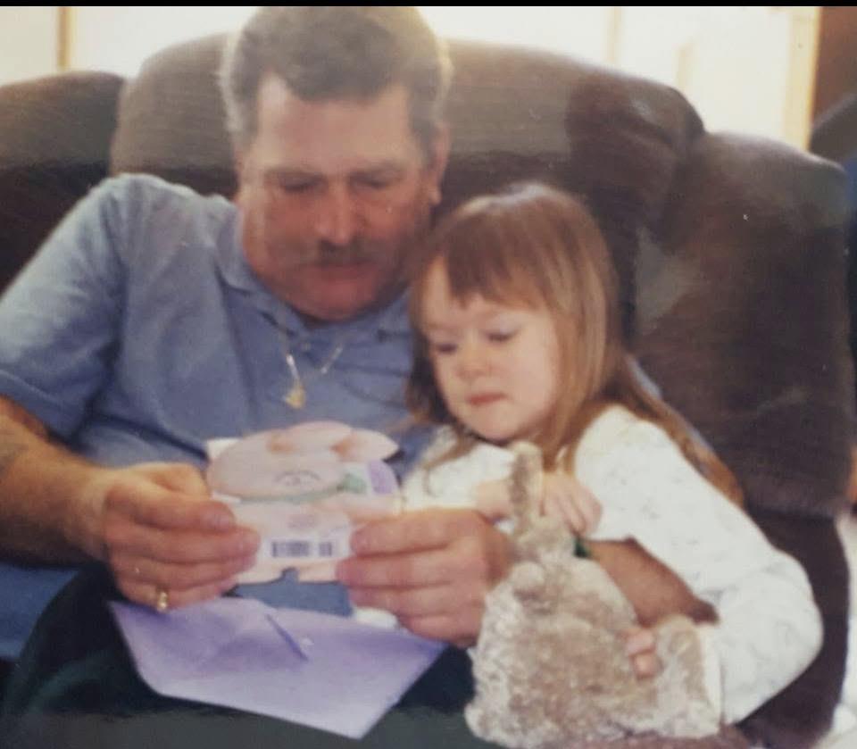 A man and a child sitting on a couch